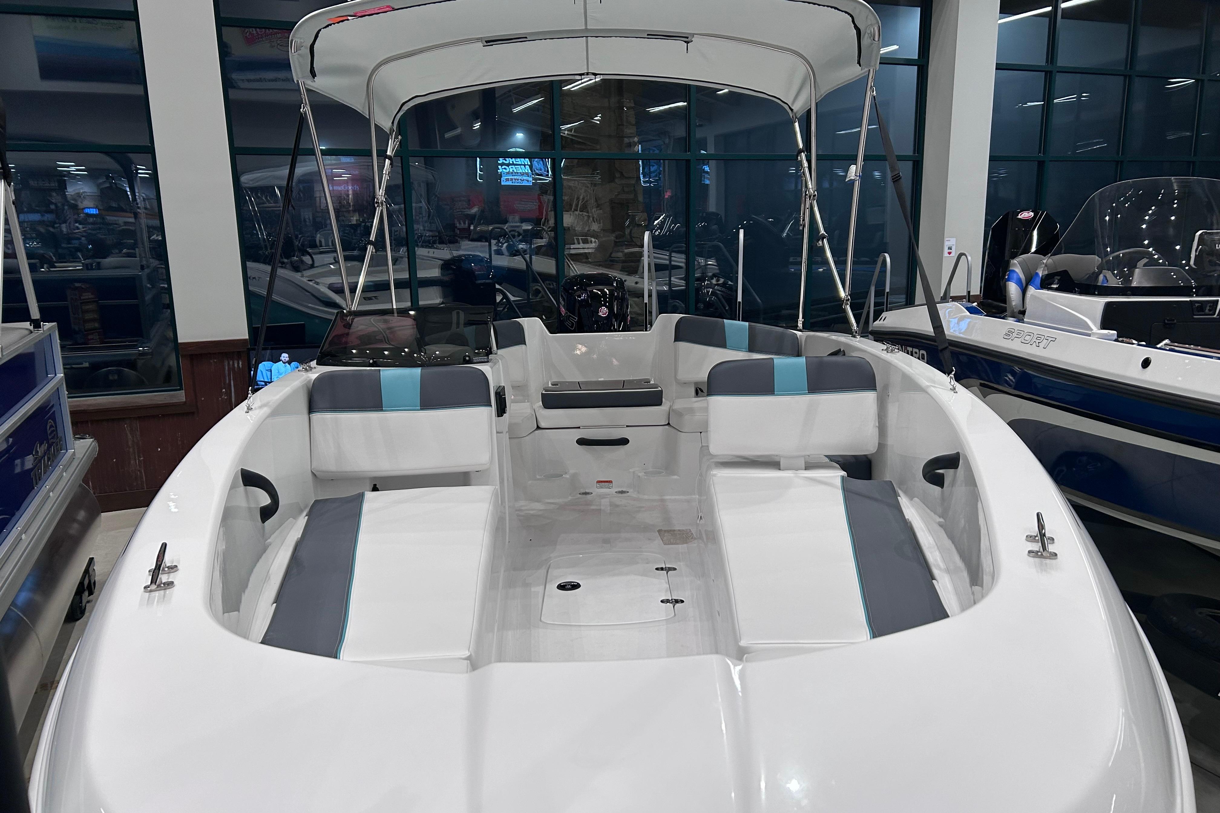 2026 Tahoe T18 boat interior with seating and canopy in showroom.