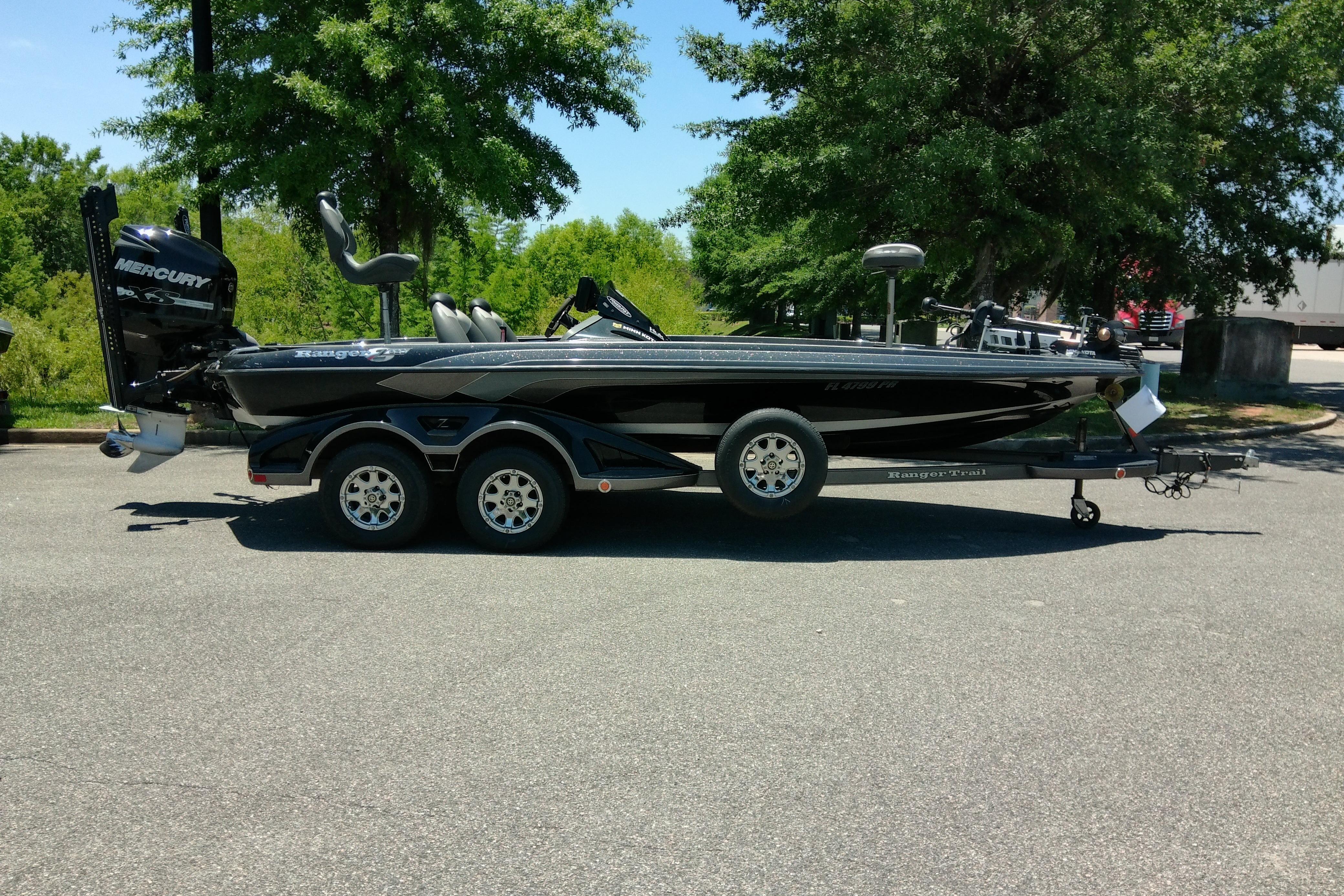 2012 Ranger Z520 boat with Mercury engine on trailer, parked outdoors.