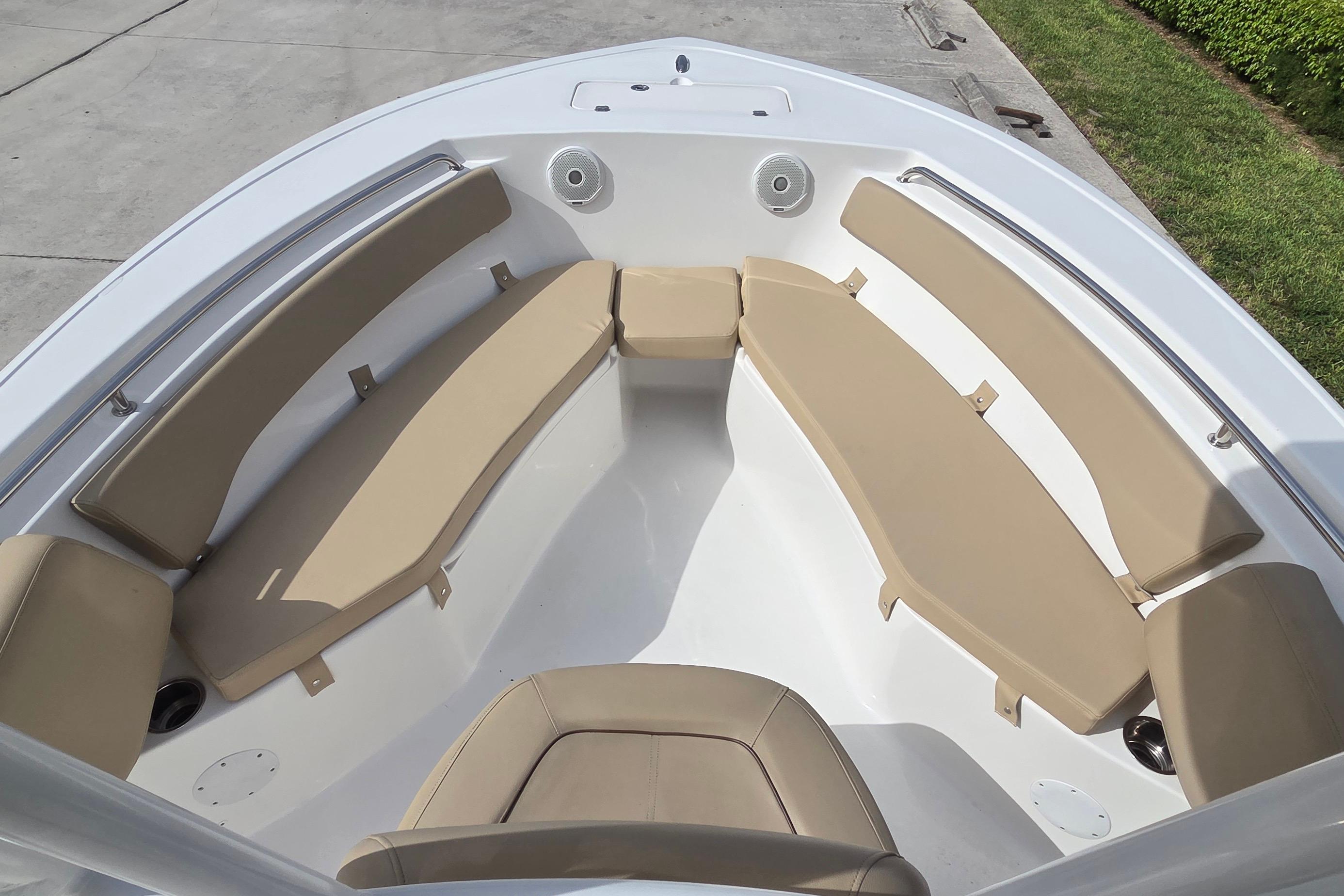 2015 Tidewater 220 LXF boat interior with beige seating and stainless steel railings.