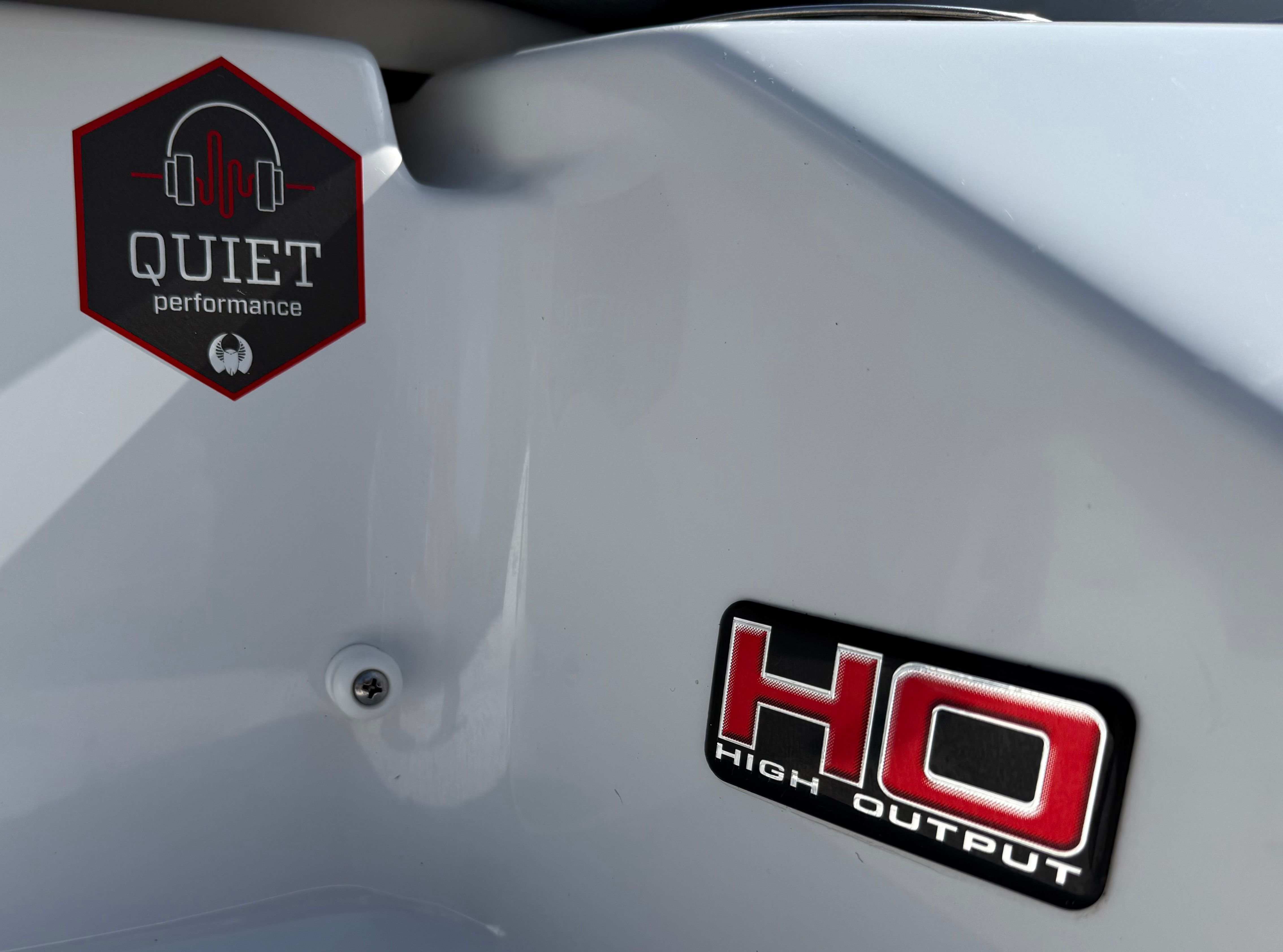 Close-up of a boat part with "Quiet Performance" and "High Output" badges.
