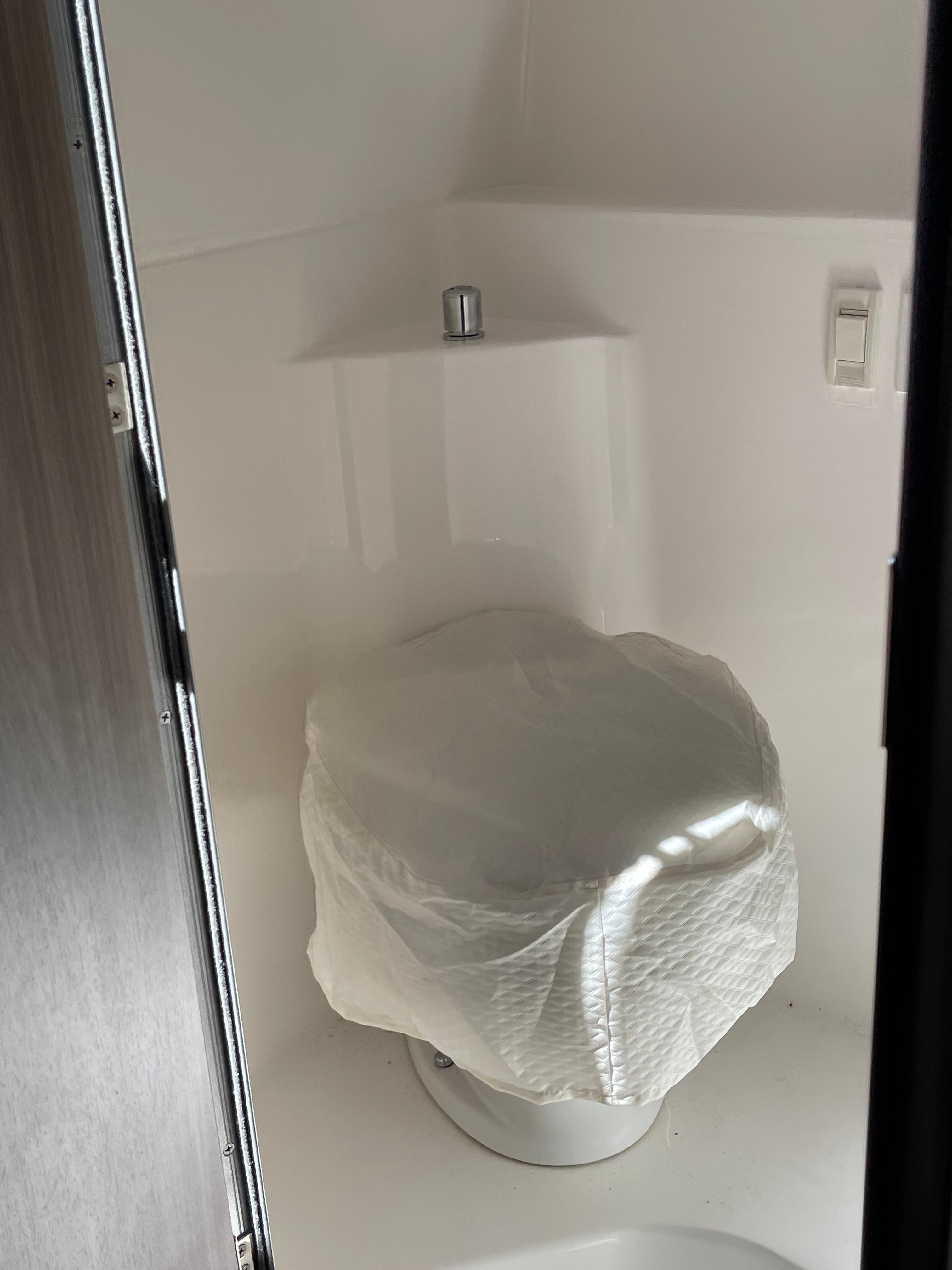 Regal 26 Express 2022 boat toilet with cover.