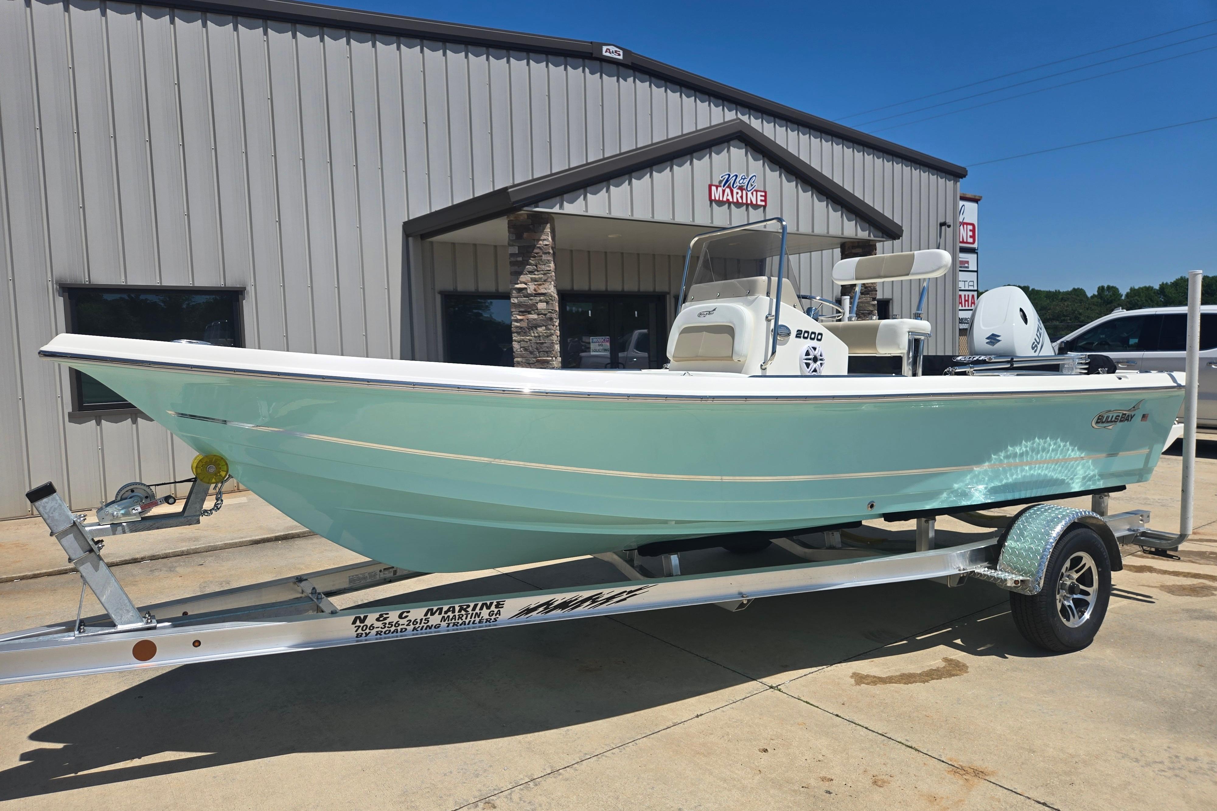 2026 Bulls Bay 2000 boat on trailer outside marine dealership.