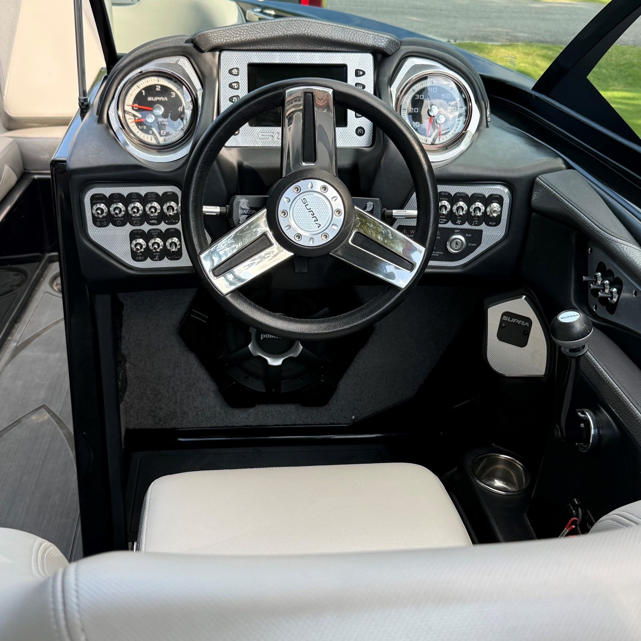 The cockpit of a 2014 Supra SC350 with a modern dashboard and steering wheel.