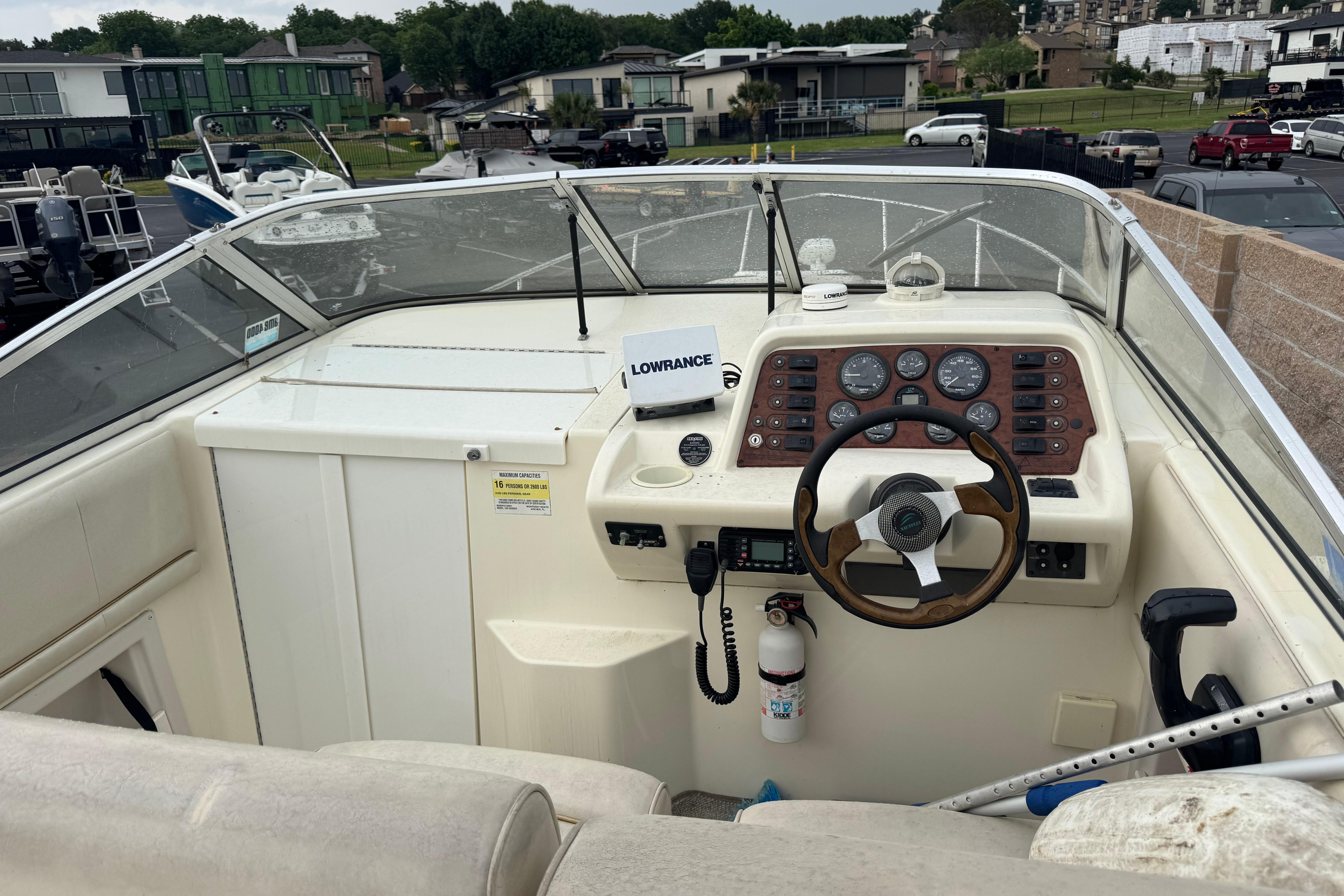 1997 Monterey 256 Cruiser boat cockpit with steering wheel and control panel.