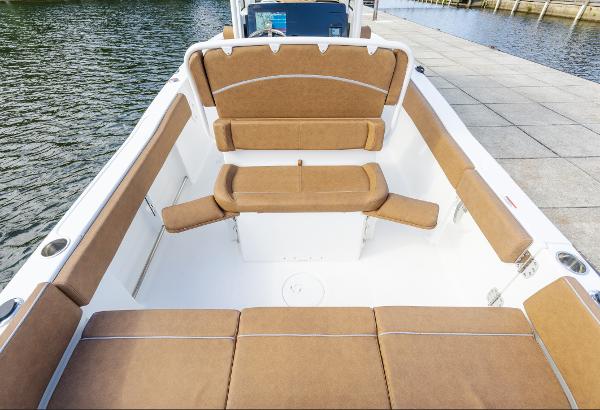 2025 Sea Hunt Ultra 235 SE boat interior with tan seating, dockside view.