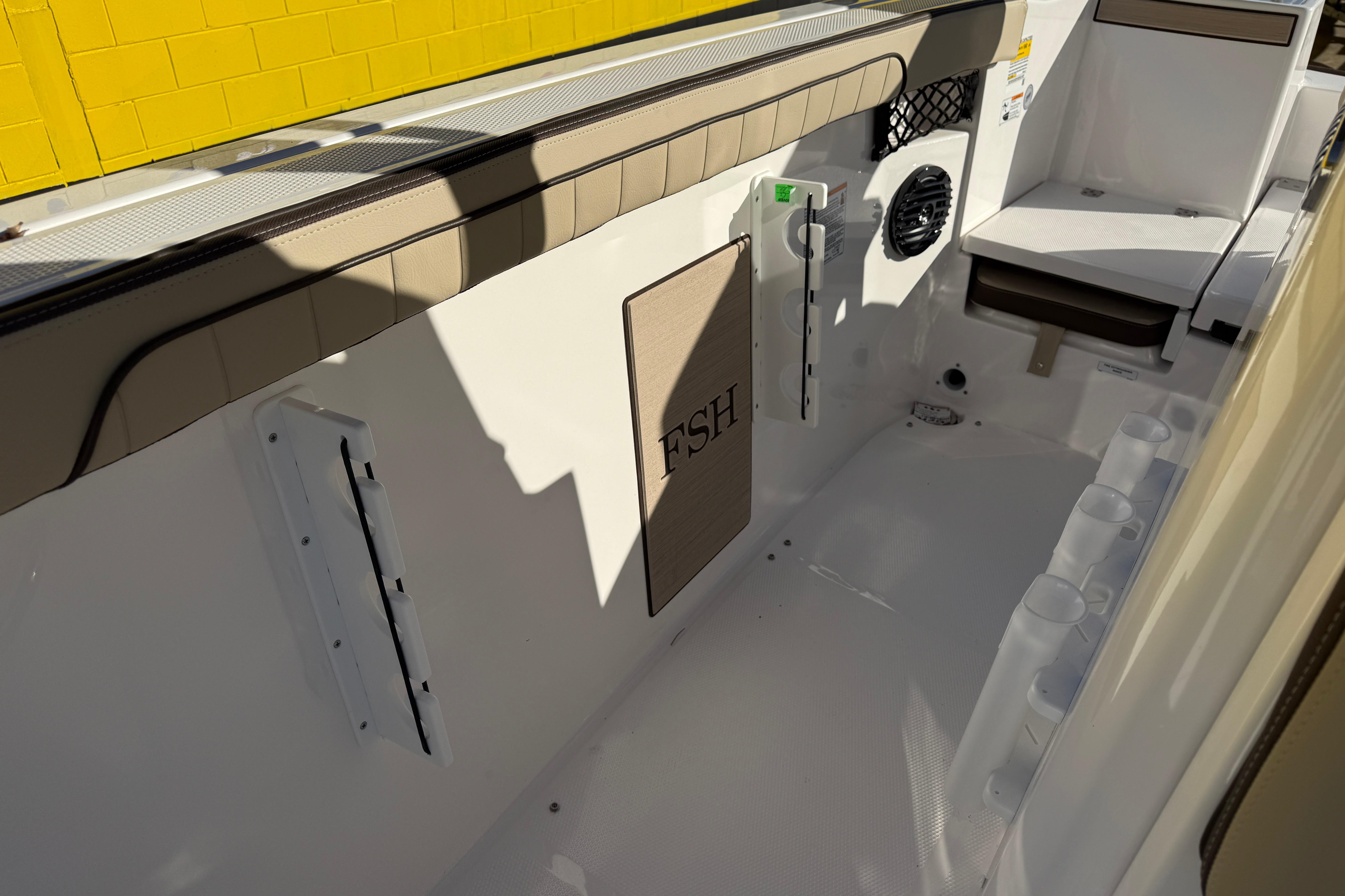 2026 Yamaha Boats 222 FSH Sport E interior with seating and storage features.