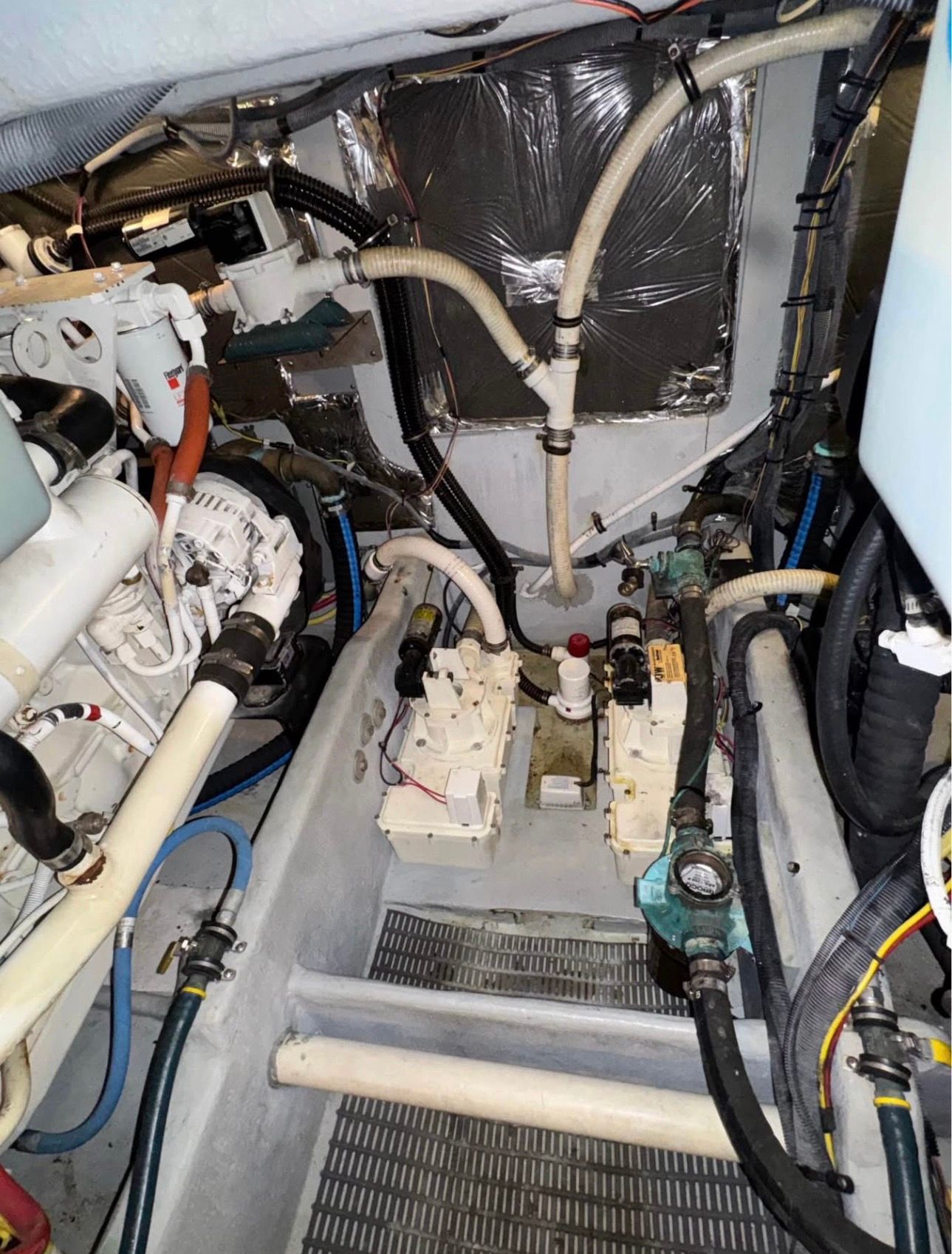 Engine room of a 2007 Meridian 411 Sedan boat with hoses and machinery.