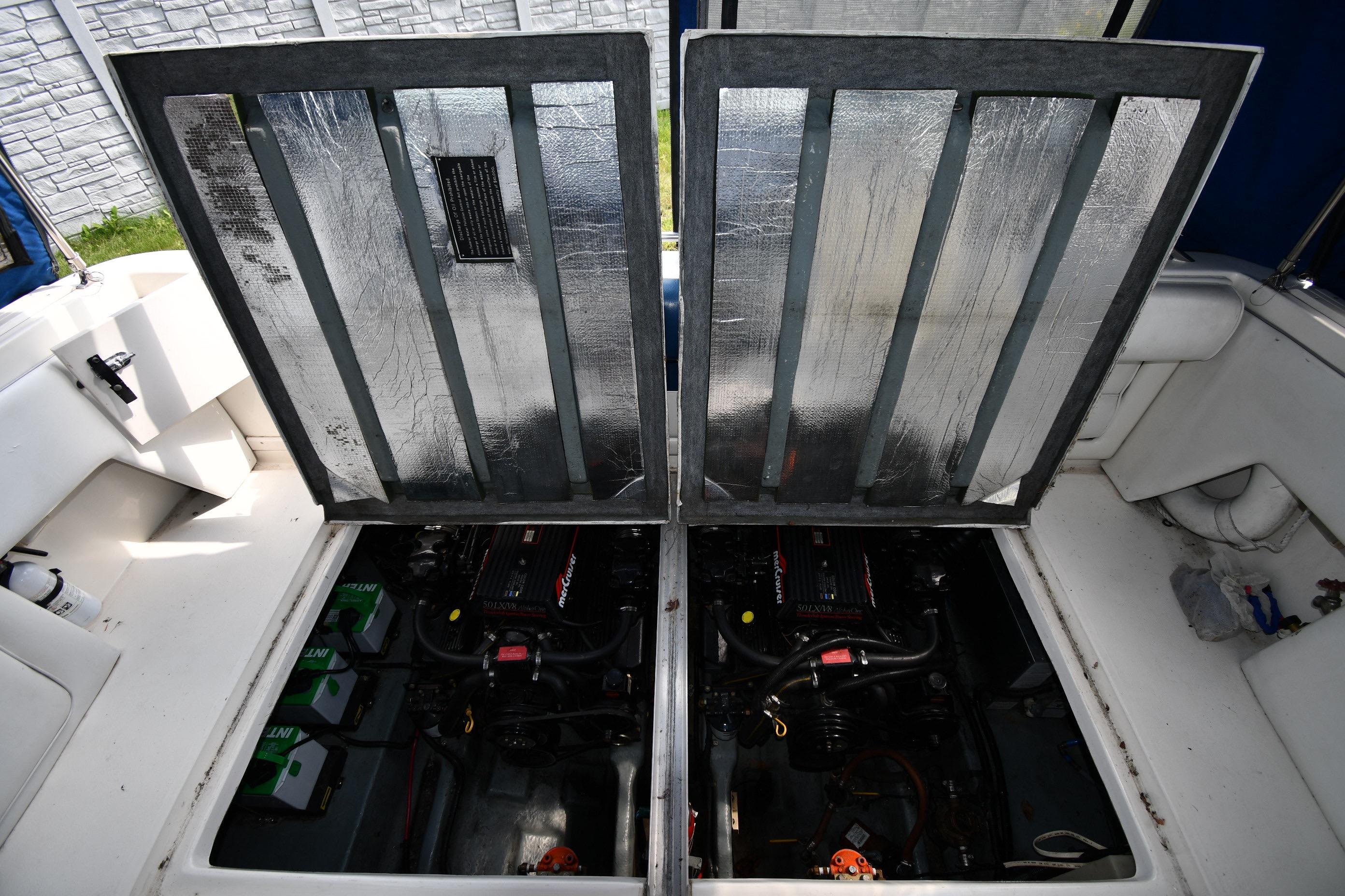 Engine compartment of a 1993 Sea Ray 300 Sundancer boat, showcasing dual engines.