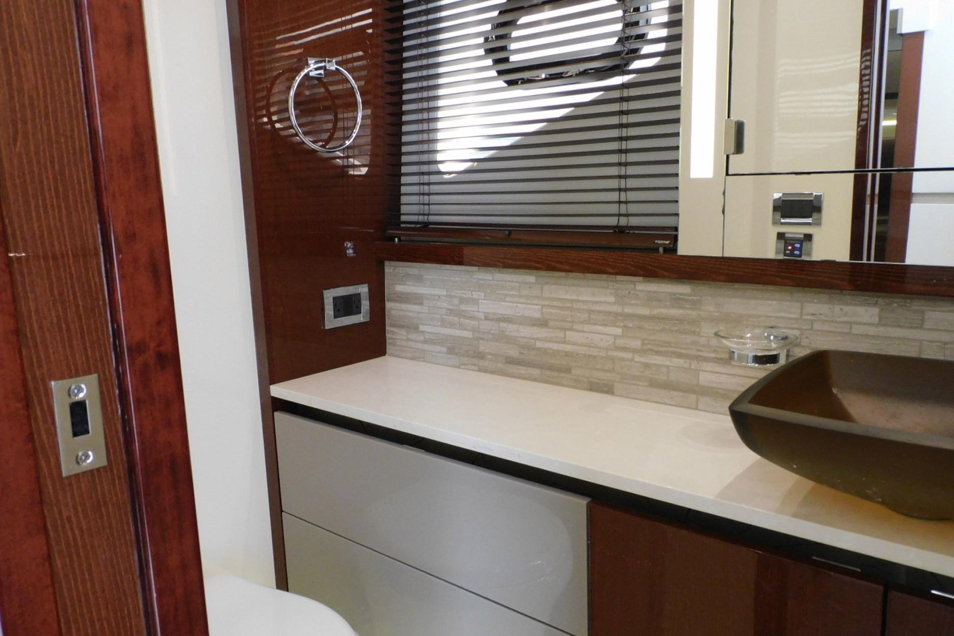 Luxurious bathroom interior of 2019 Sea Ray L550 yacht with modern fixtures and elegant design.