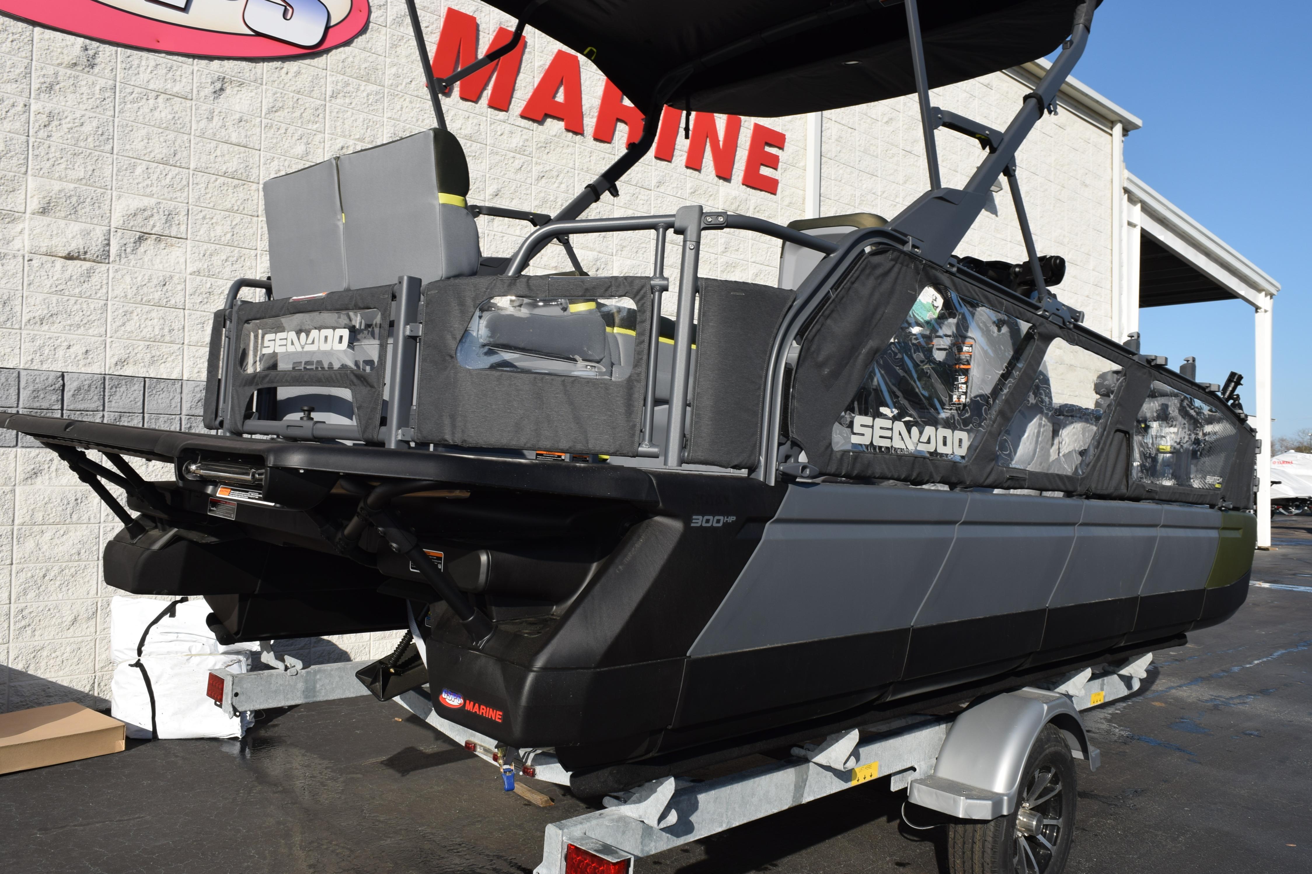 2026 Sea-Doo Switch Fish 21 boat on trailer outside marine store.