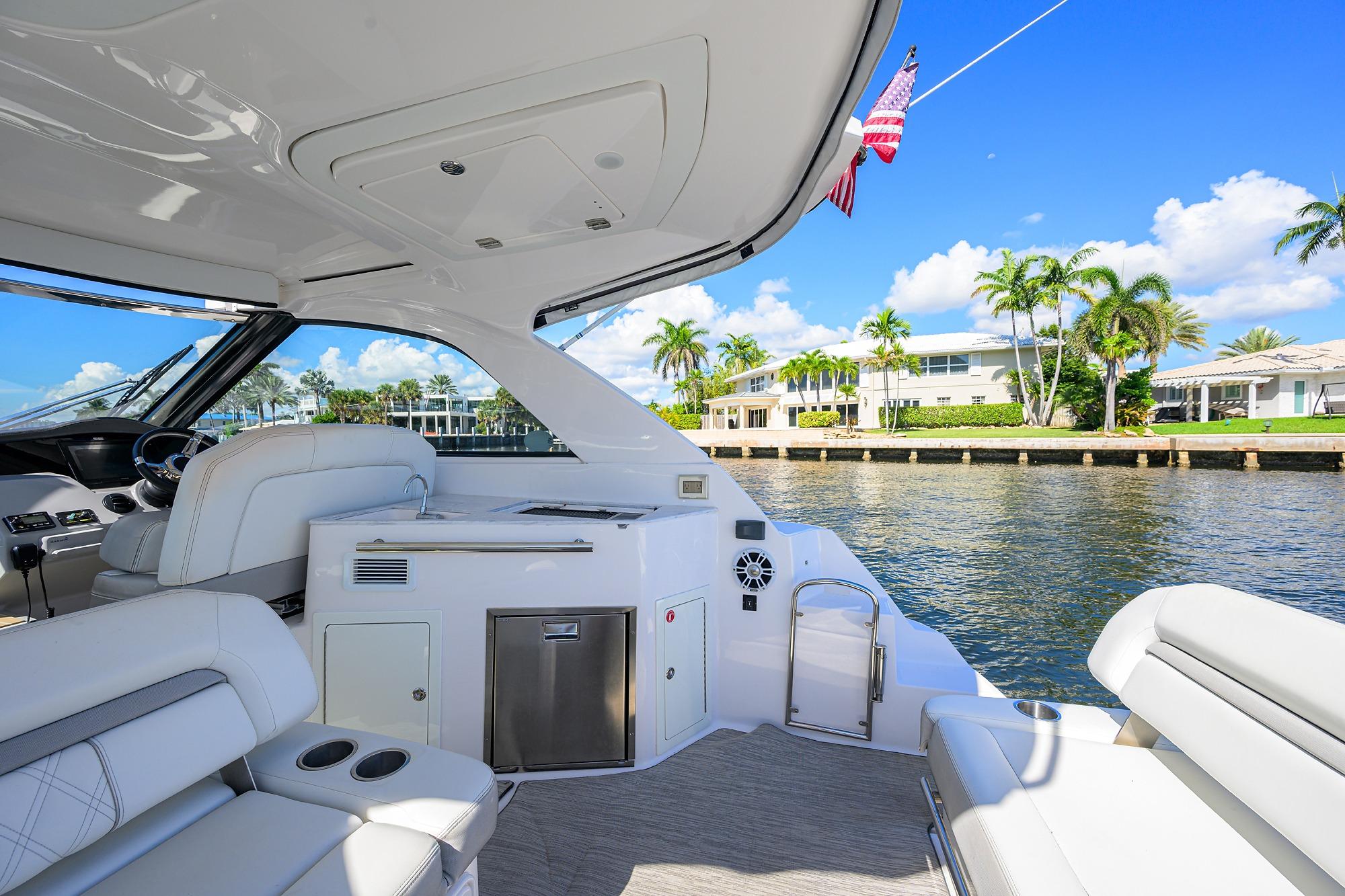 2020 Regal 35 Sport Coupe yacht interior with waterfront view, featuring luxurious seating and amenities.