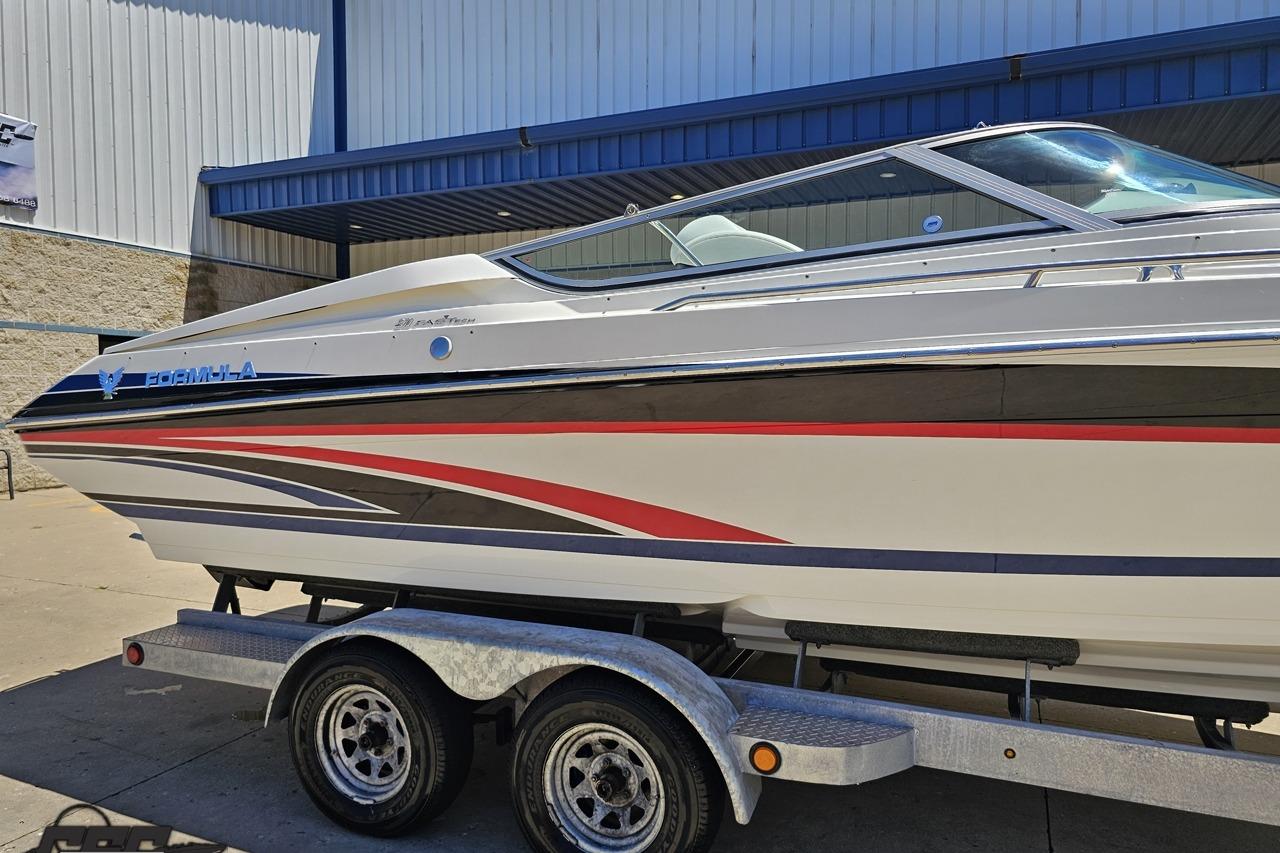 2005 Formula 271 FASTech boat on trailer, featuring sleek design and vibrant graphics.