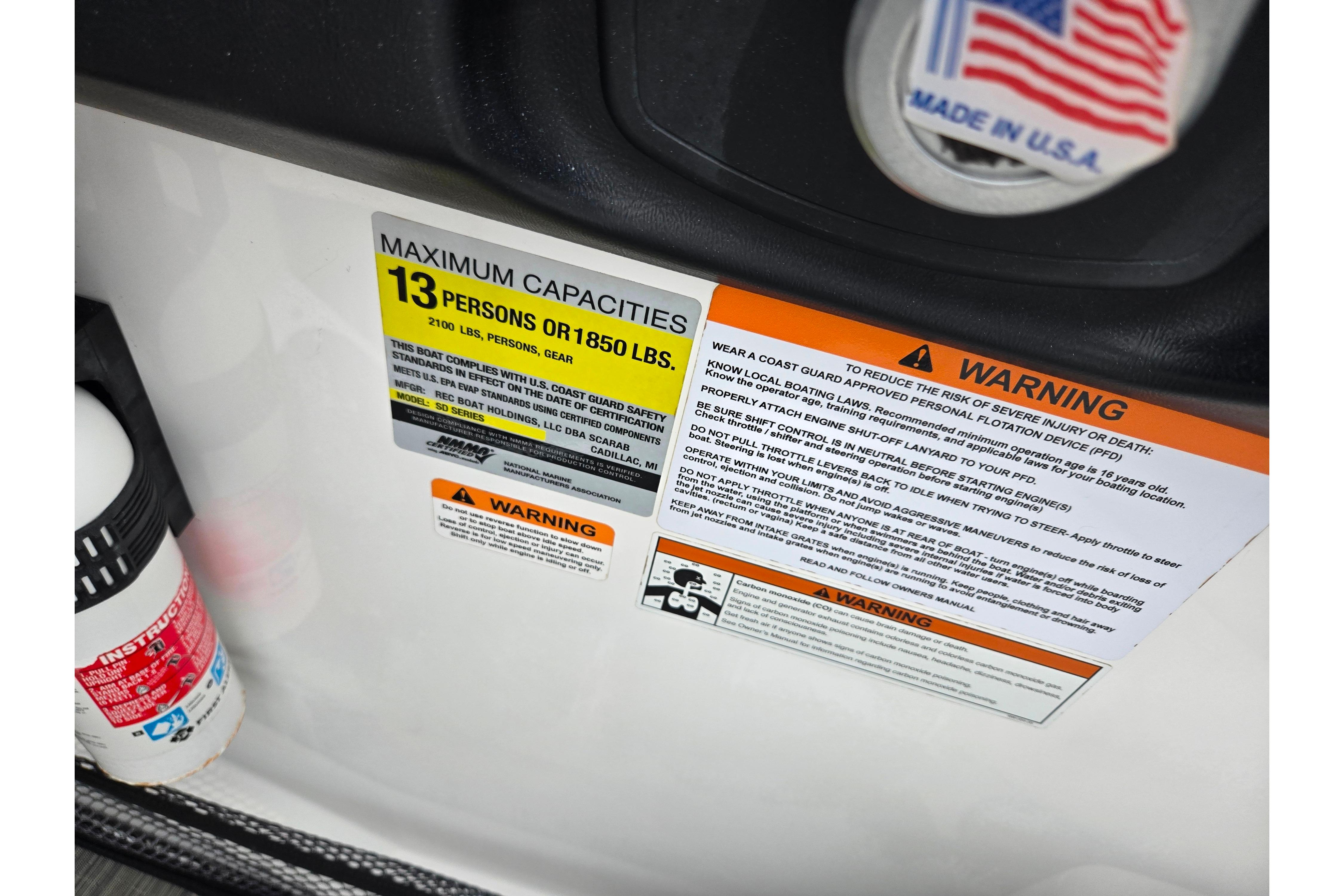 Scarab 255 ID 2021 boat capacity warning labels, maximum 13 persons or 1850 lbs, made in USA.