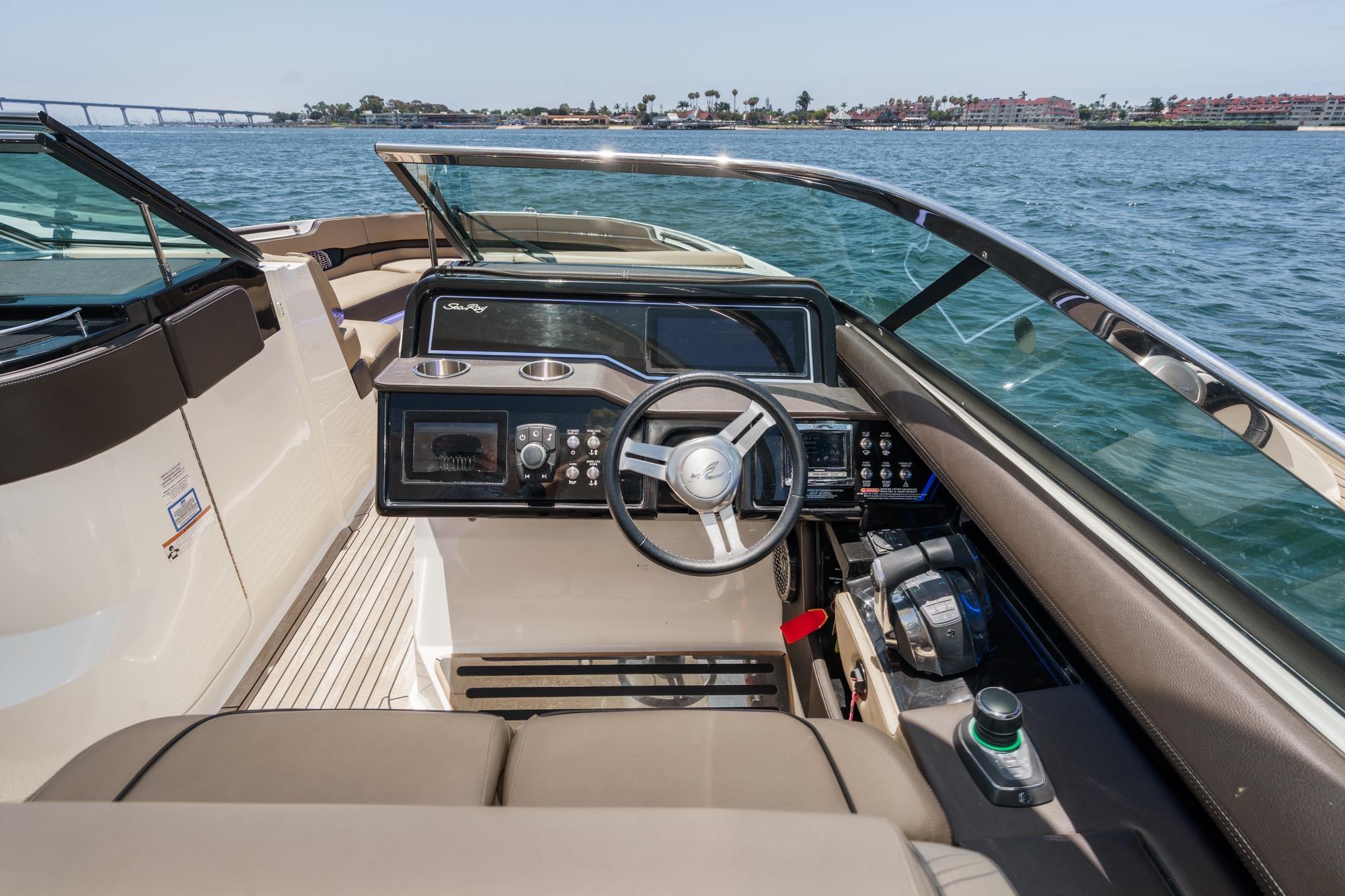 2018 Sea Ray SLX 310 boat interior with steering wheel and control panel on open water.
