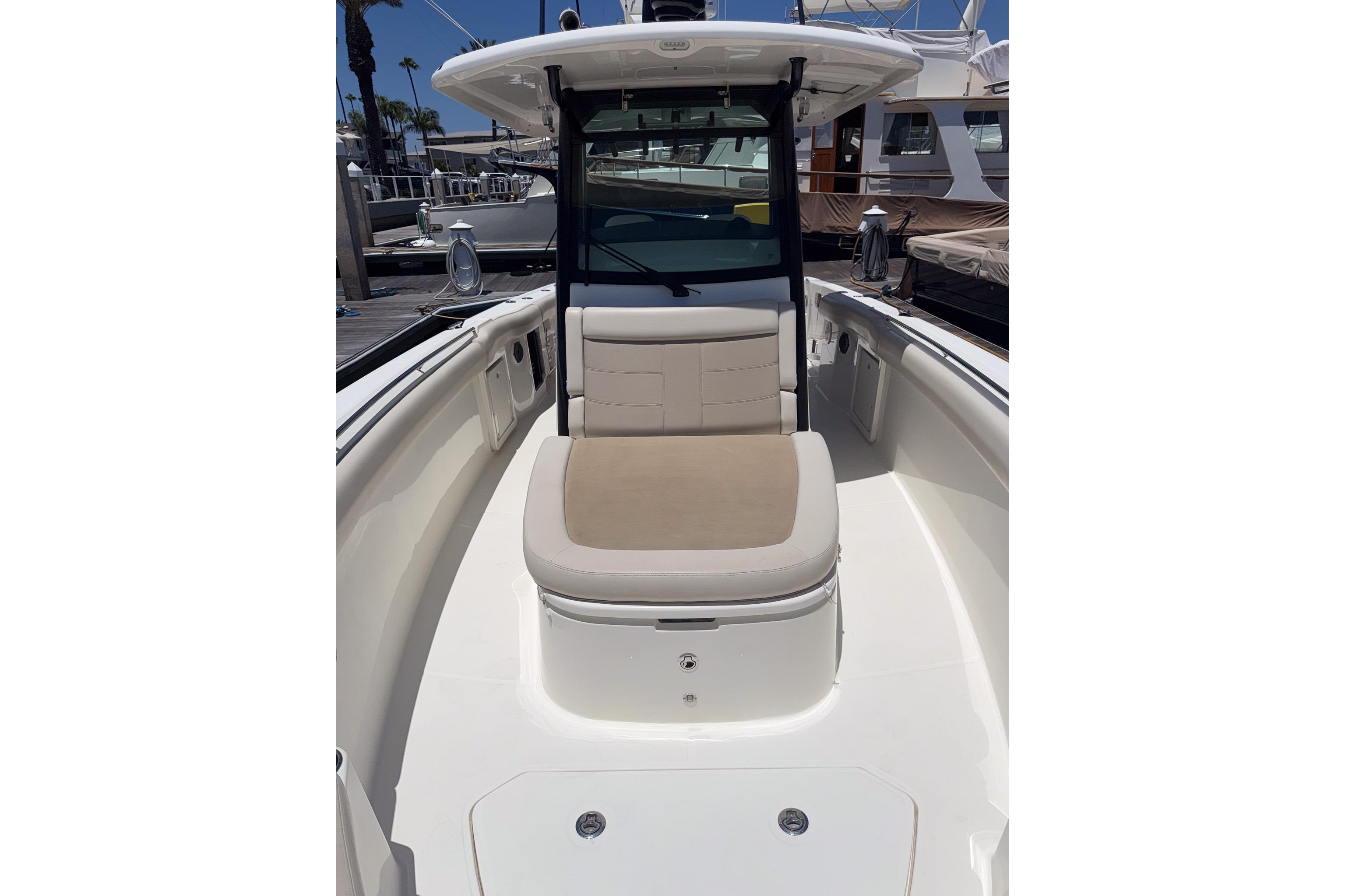 2021 Boston Whaler 330 Outrage boat interior with cushioned seating and sleek design.