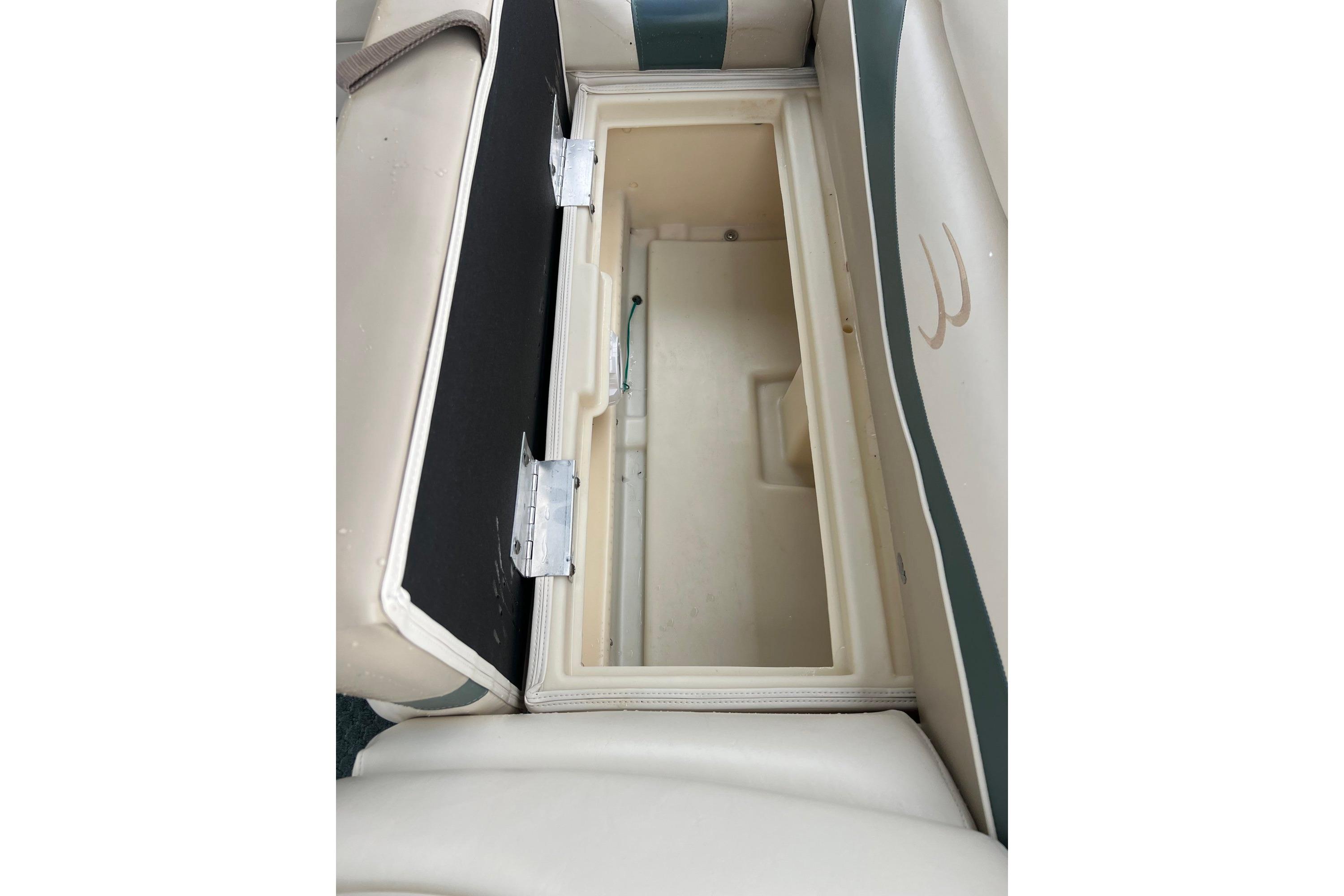 Open storage compartment on a 2006 Bennington 2575 FS boat seat.
