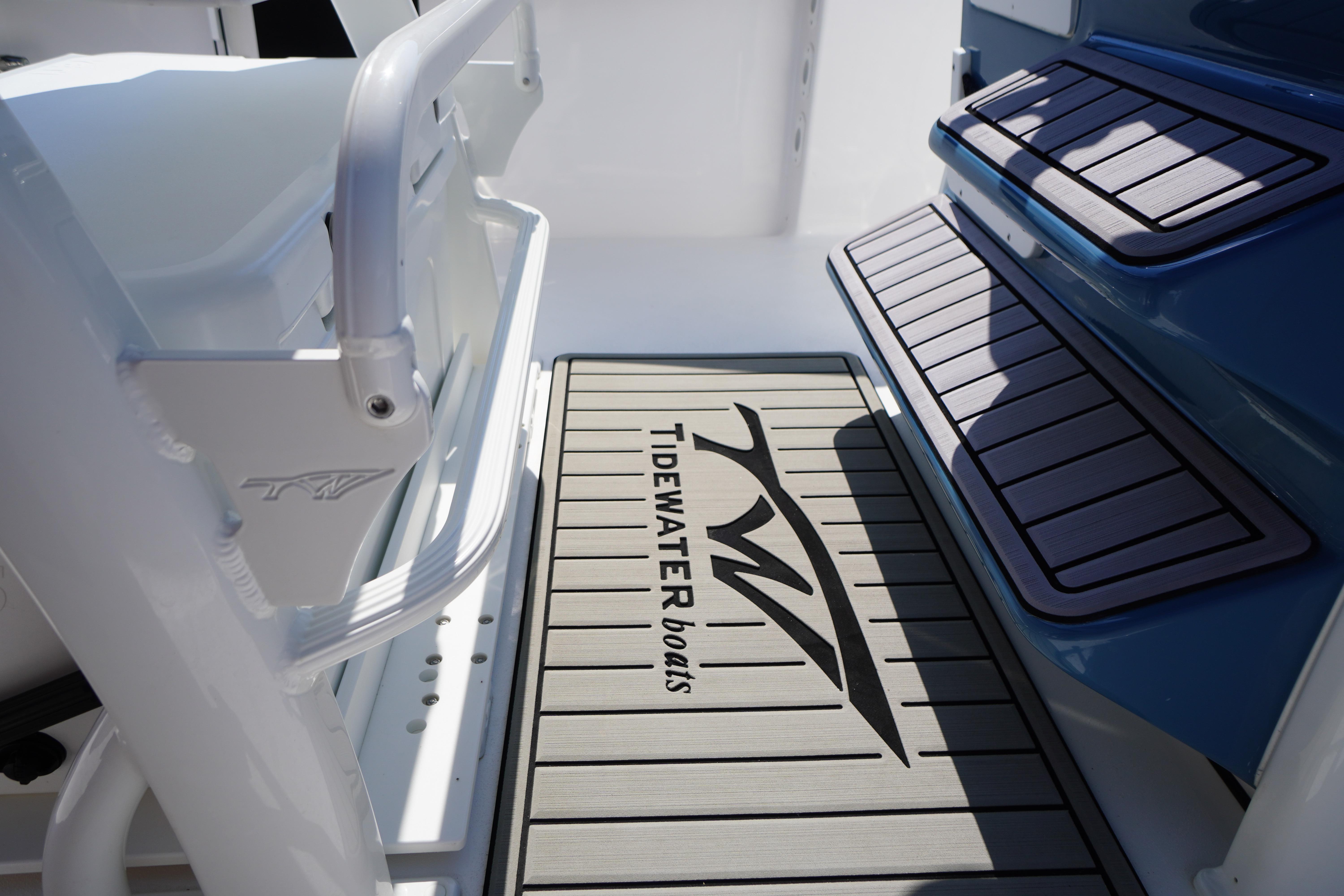 2025 Tidewater 232 SS boat deck with branded mat and seating area.