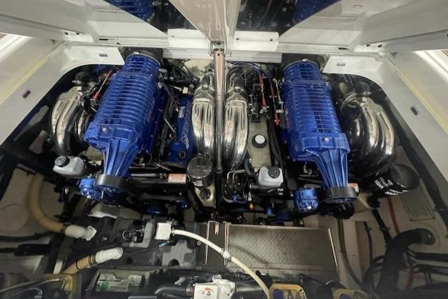 Engine compartment of a 2007 Formula 382 FASTech boat, featuring dual blue supercharged engines.