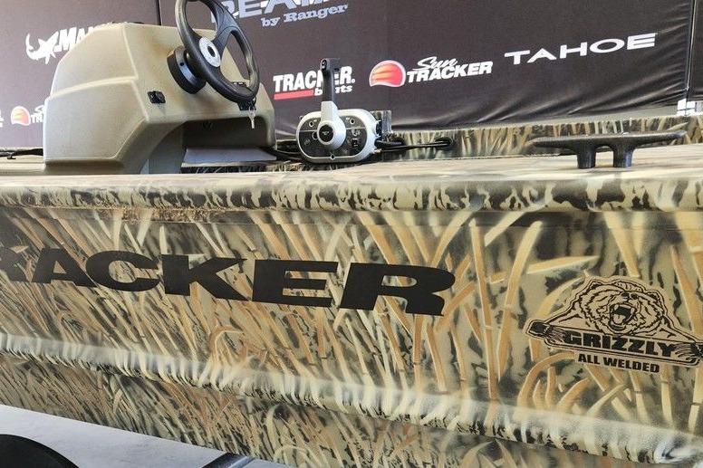 2026 Tracker Grizzly 1648 SC boat with camouflage design and steering console.