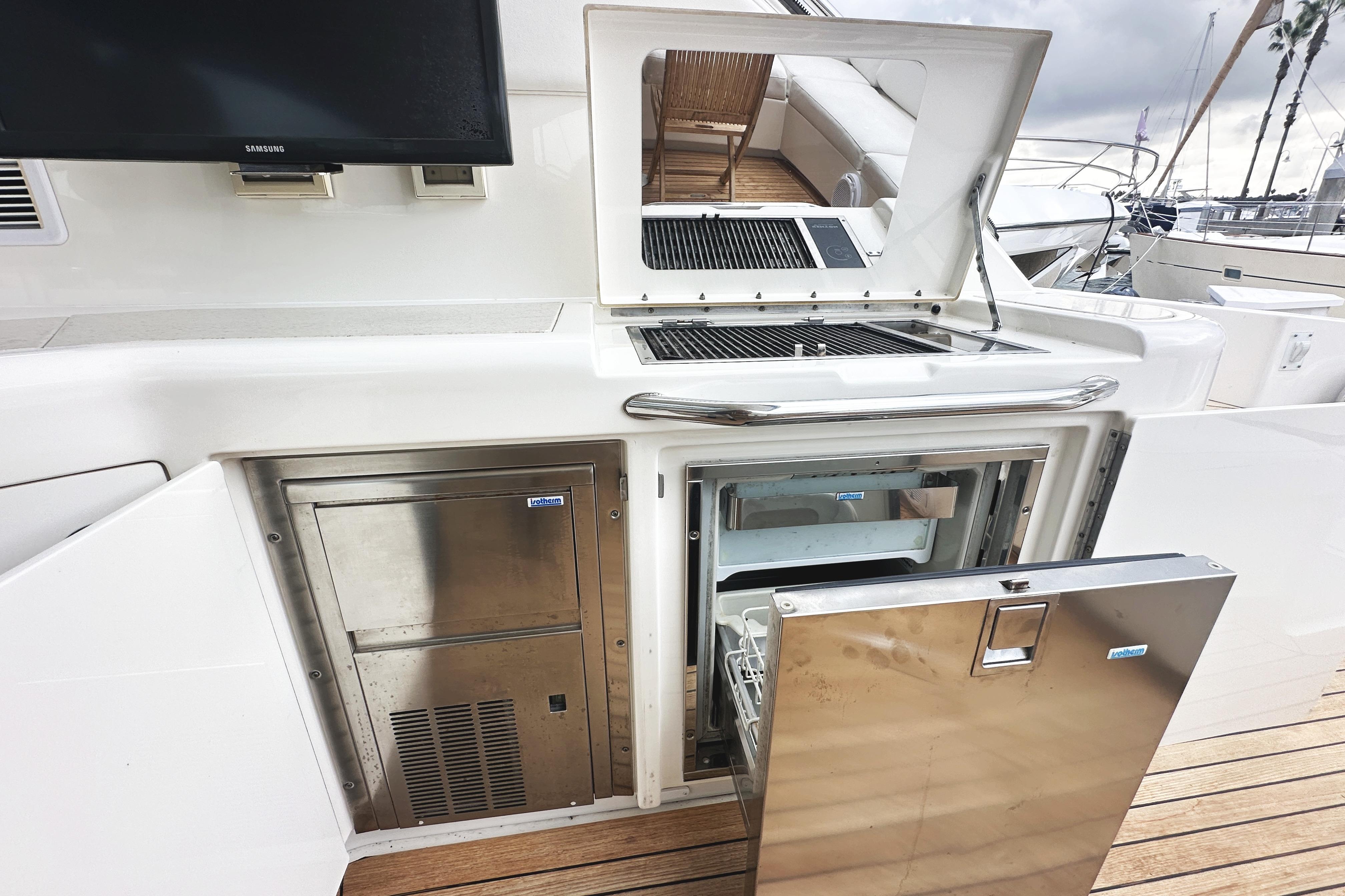 Outdoor kitchen on 2010 Sea Ray Sundancer 540 yacht with grill and stainless steel appliances.