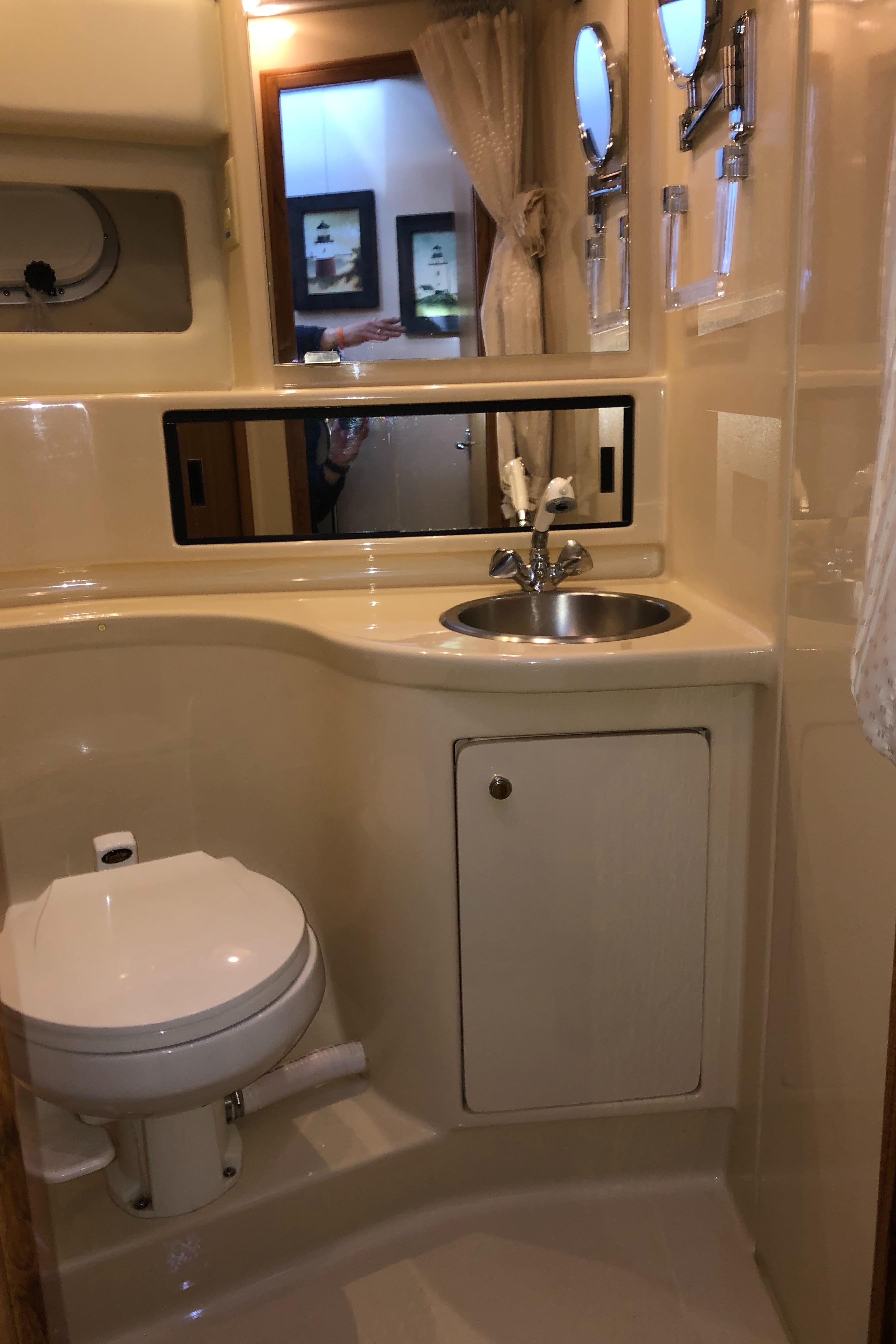 2002 Bayliner 39 Motor Yacht bathroom with sink, toilet, and mirror.