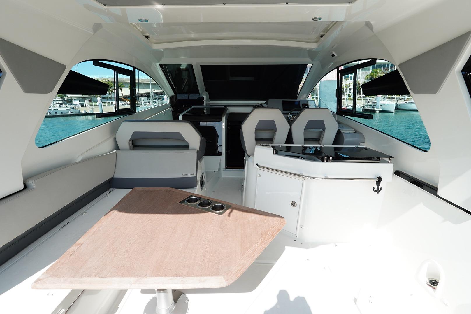 Interior of 2023 Beneteau Gran Turismo 32 yacht, featuring modern seating and table.