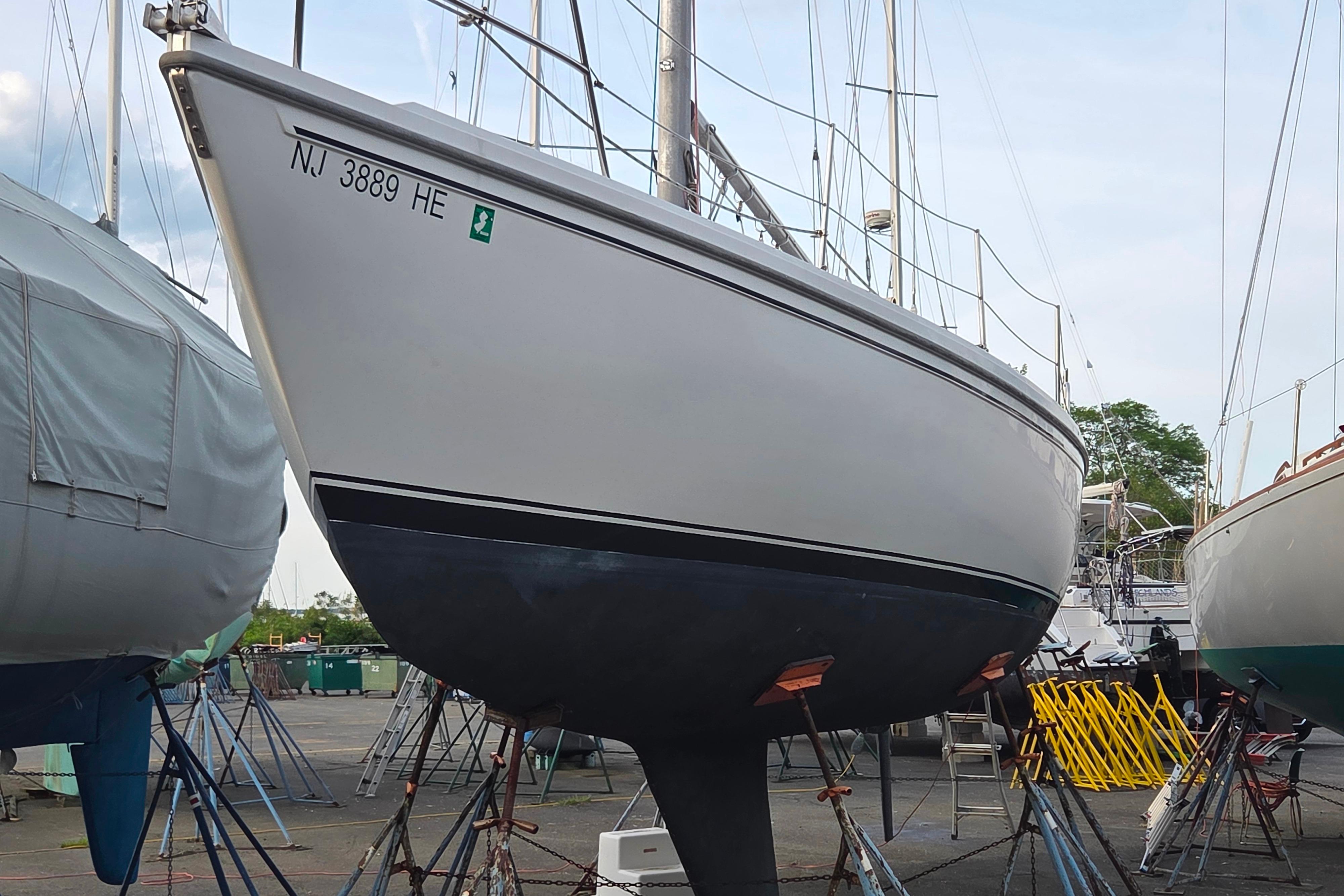 1986 Catalina 355 sailboat on dry dock, New Jersey registration visible.