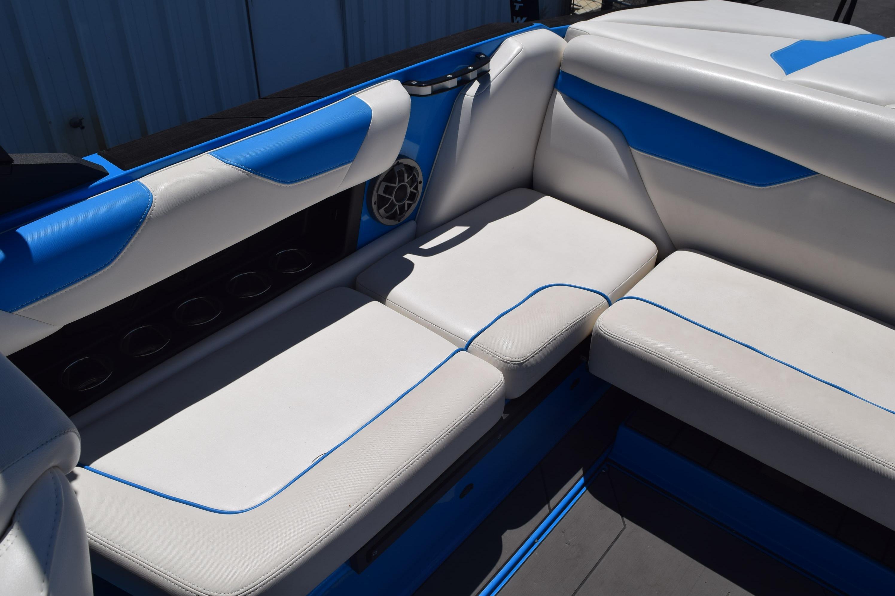 2019 Axis A22 boat interior with blue and white seating and speaker.