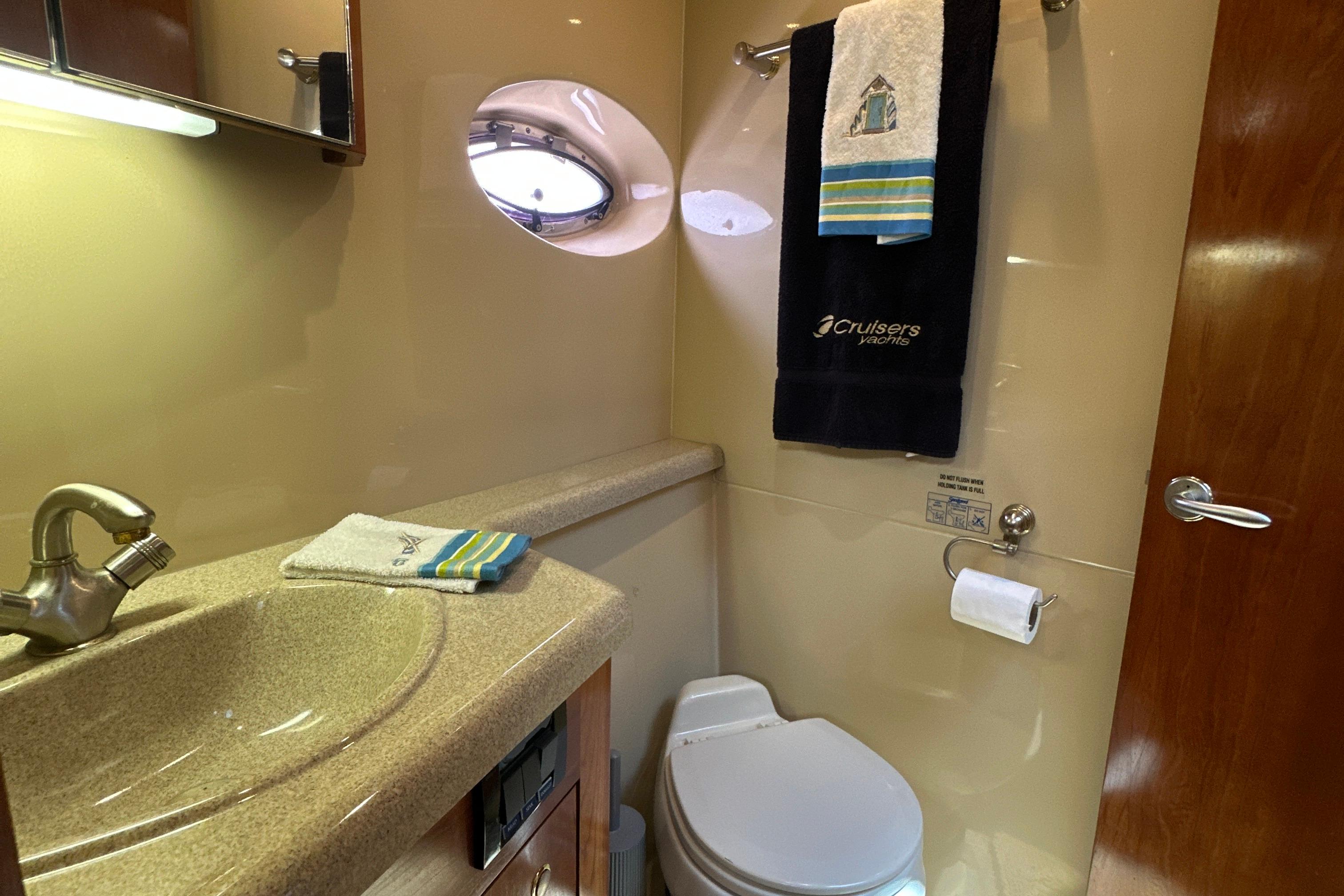 Luxurious bathroom in 2004 Cruisers Yachts 405 Express Motoryacht with elegant fixtures.