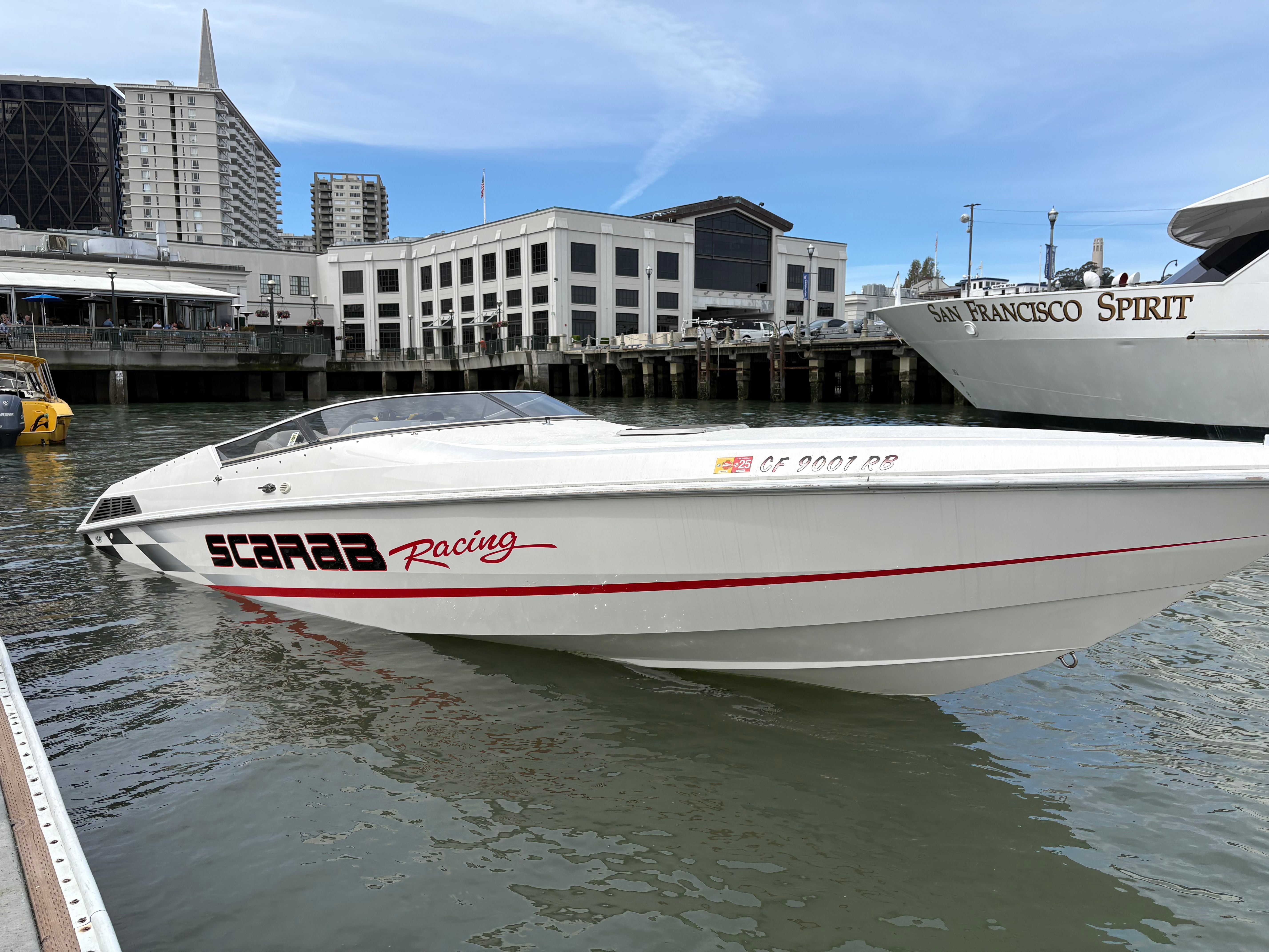 1997 Wellcraft 29 Scarab racing boat docked in San Francisco harbor.