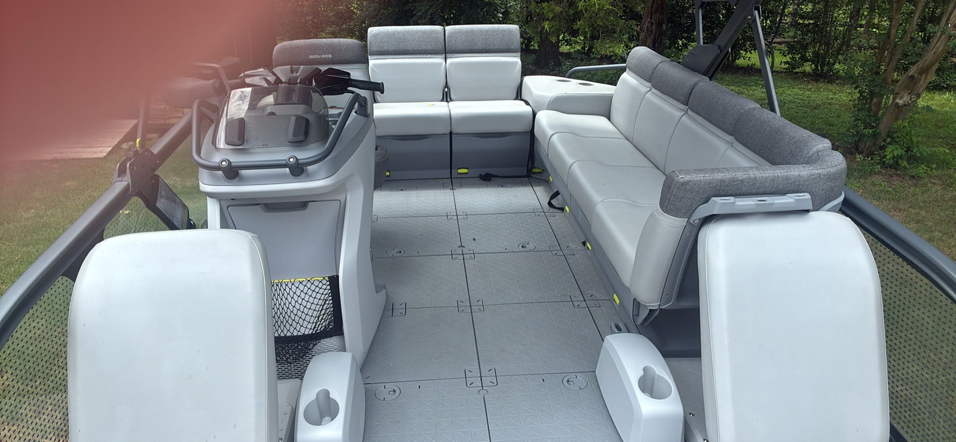Interior of a 2023 Sea-Doo Switch Sport 18 with gray seating and a helm console.