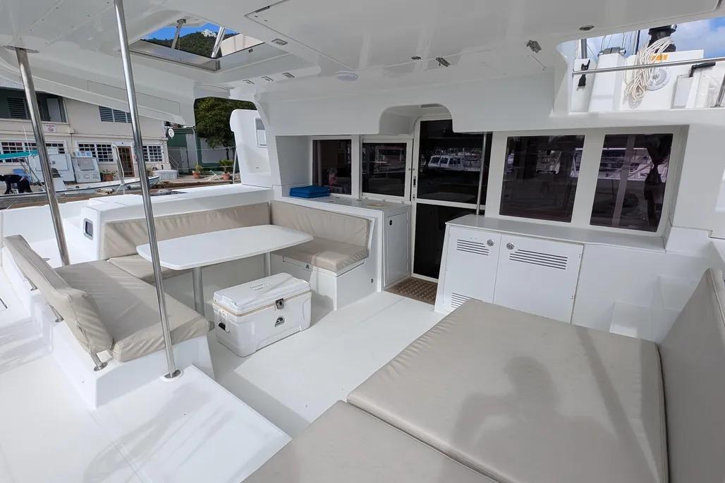 Spacious 2015 Lagoon 450 F catamaran cockpit with comfortable seating and dining area.