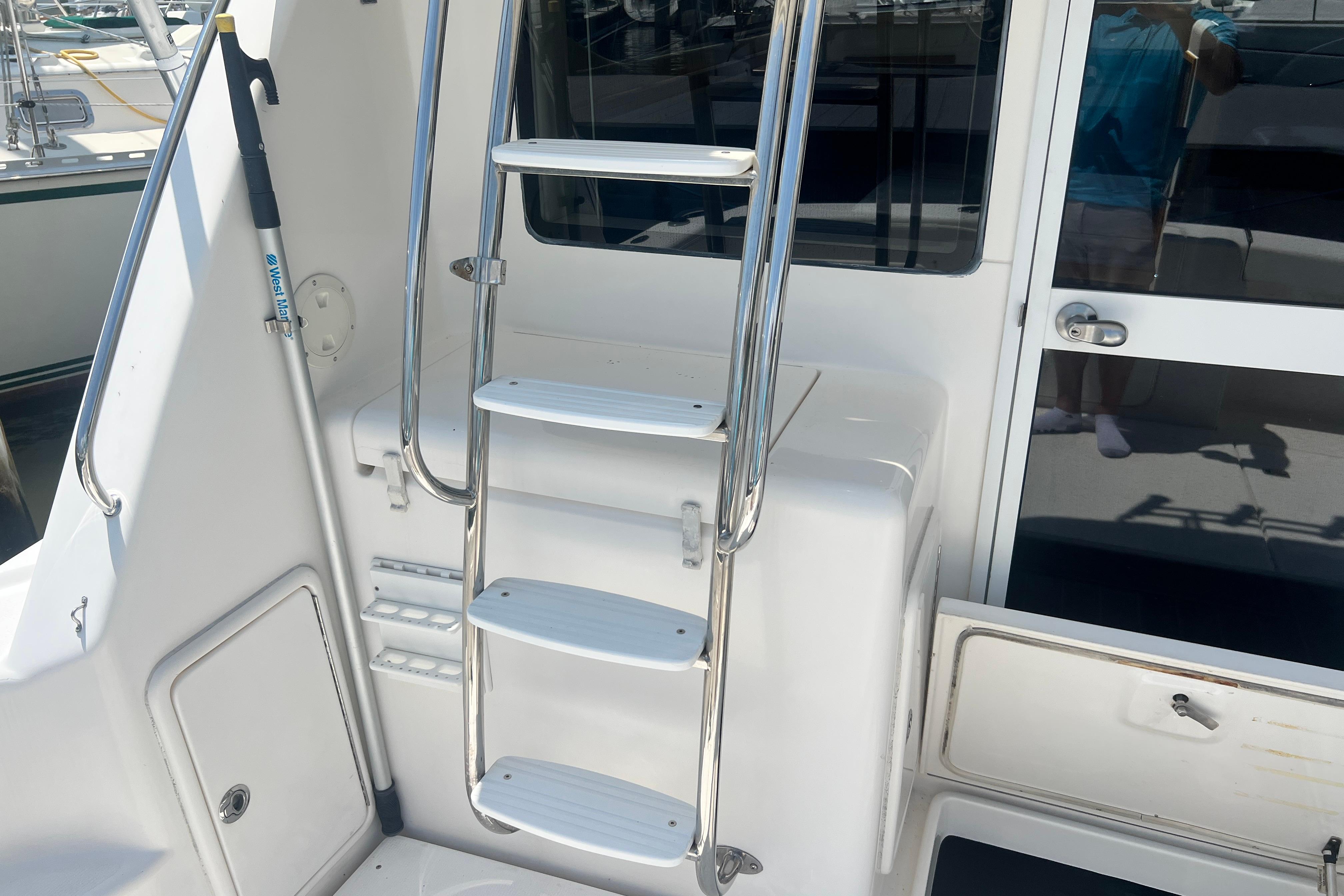 Stainless steel ladder on 2007 Riviera 33 Flybridge yacht, leading to upper deck.
