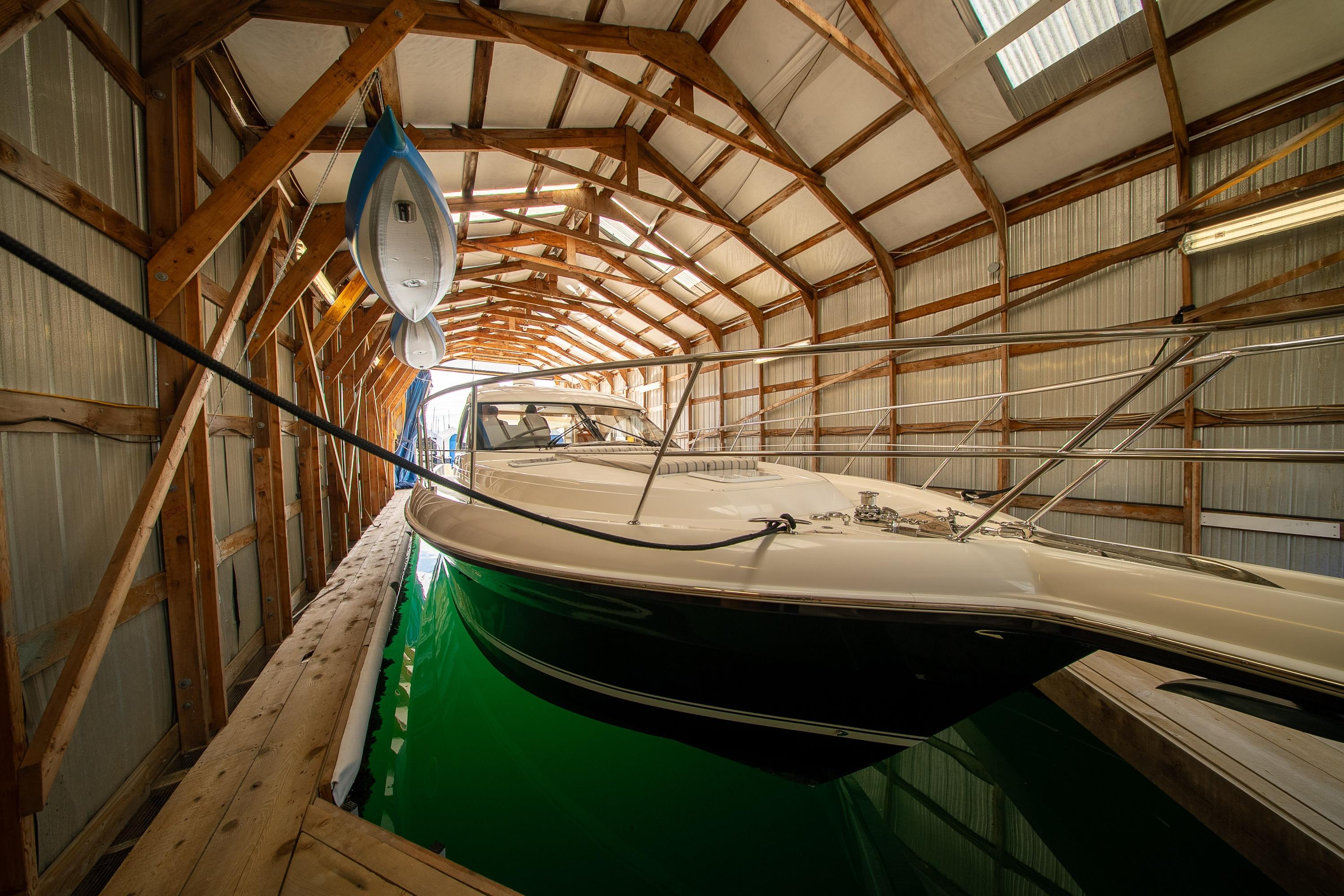 2011 Riviera 5000 Sport Yacht docked in a wooden boathouse.