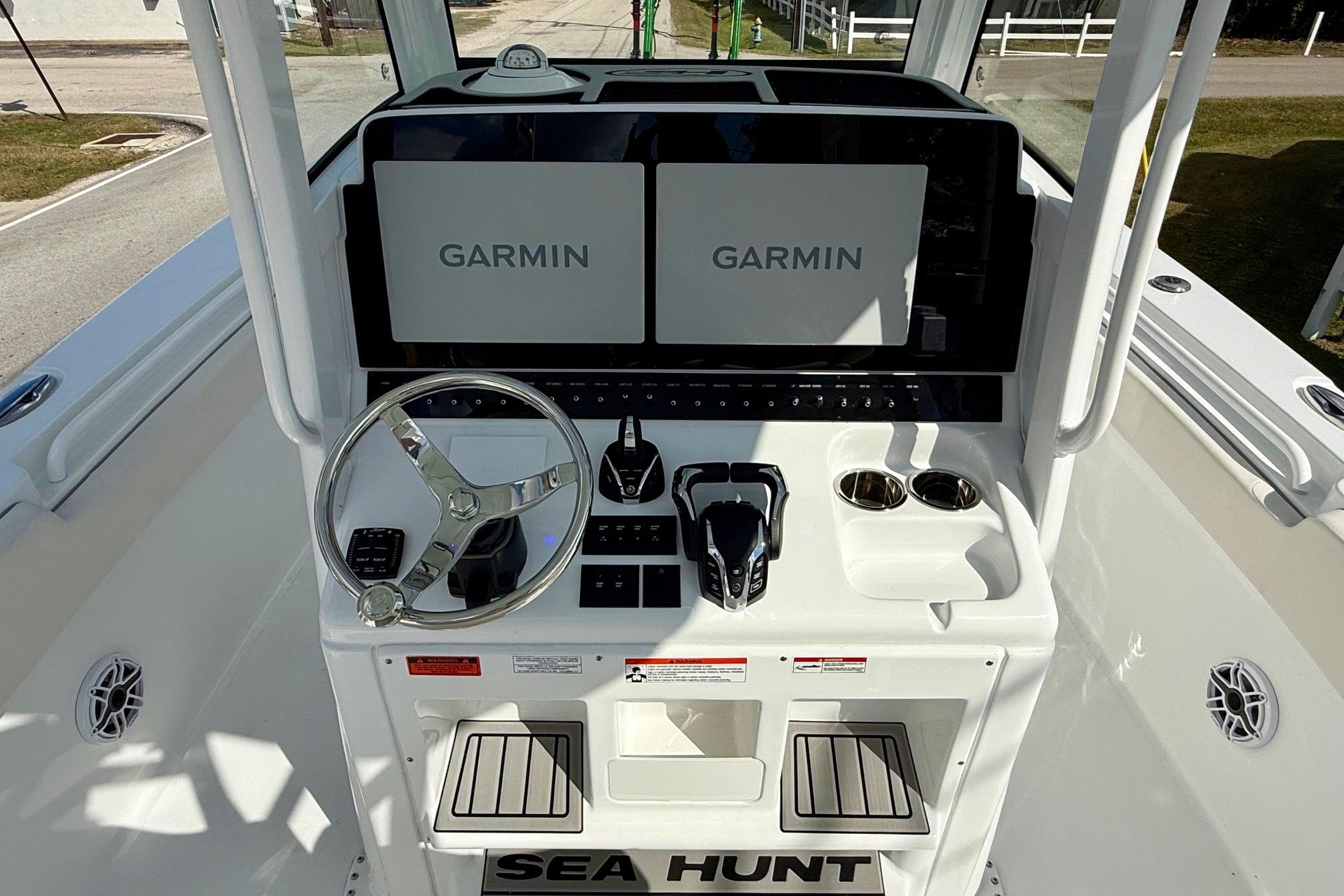 2026 Sea Hunt Ultra 285 Coffin Box boat dashboard with Garmin displays and steering wheel.