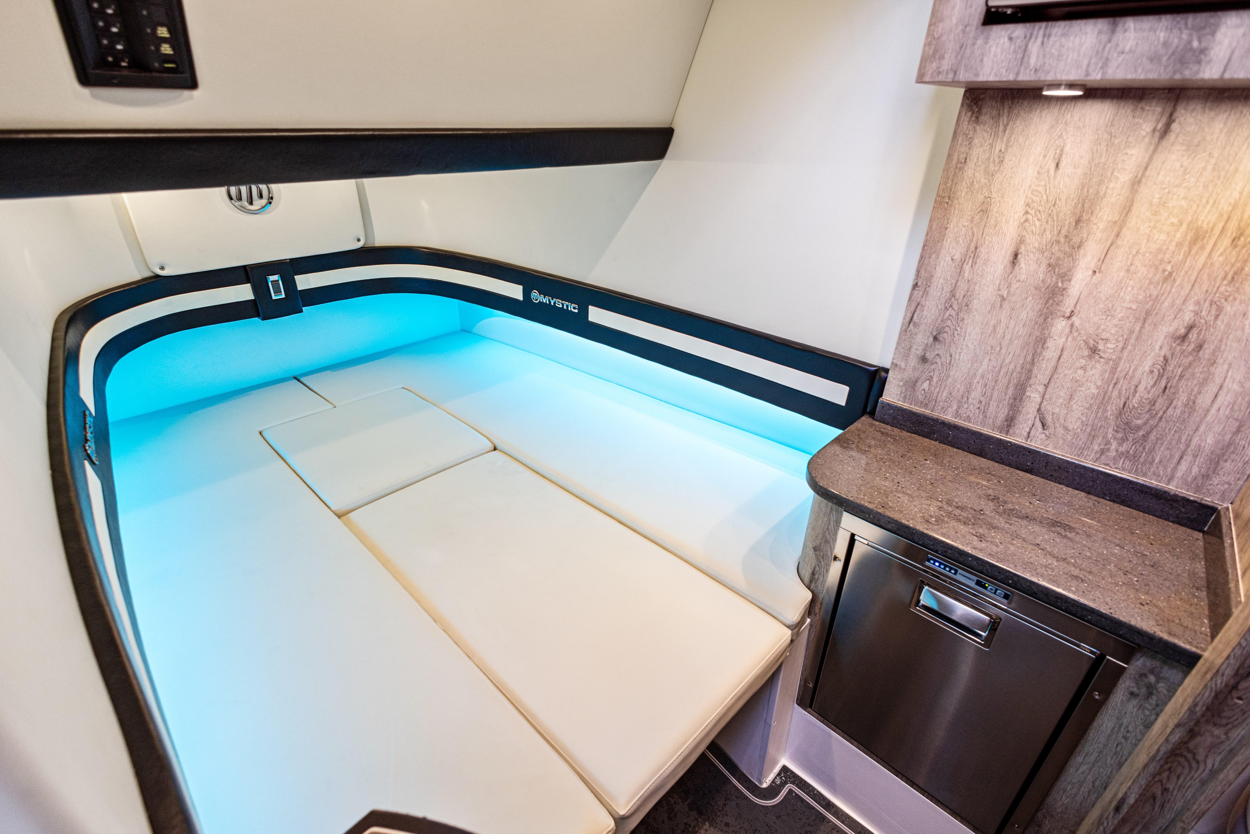 2026 Mystic Powerboats M4200 cabin interior with modern design and ambient lighting.