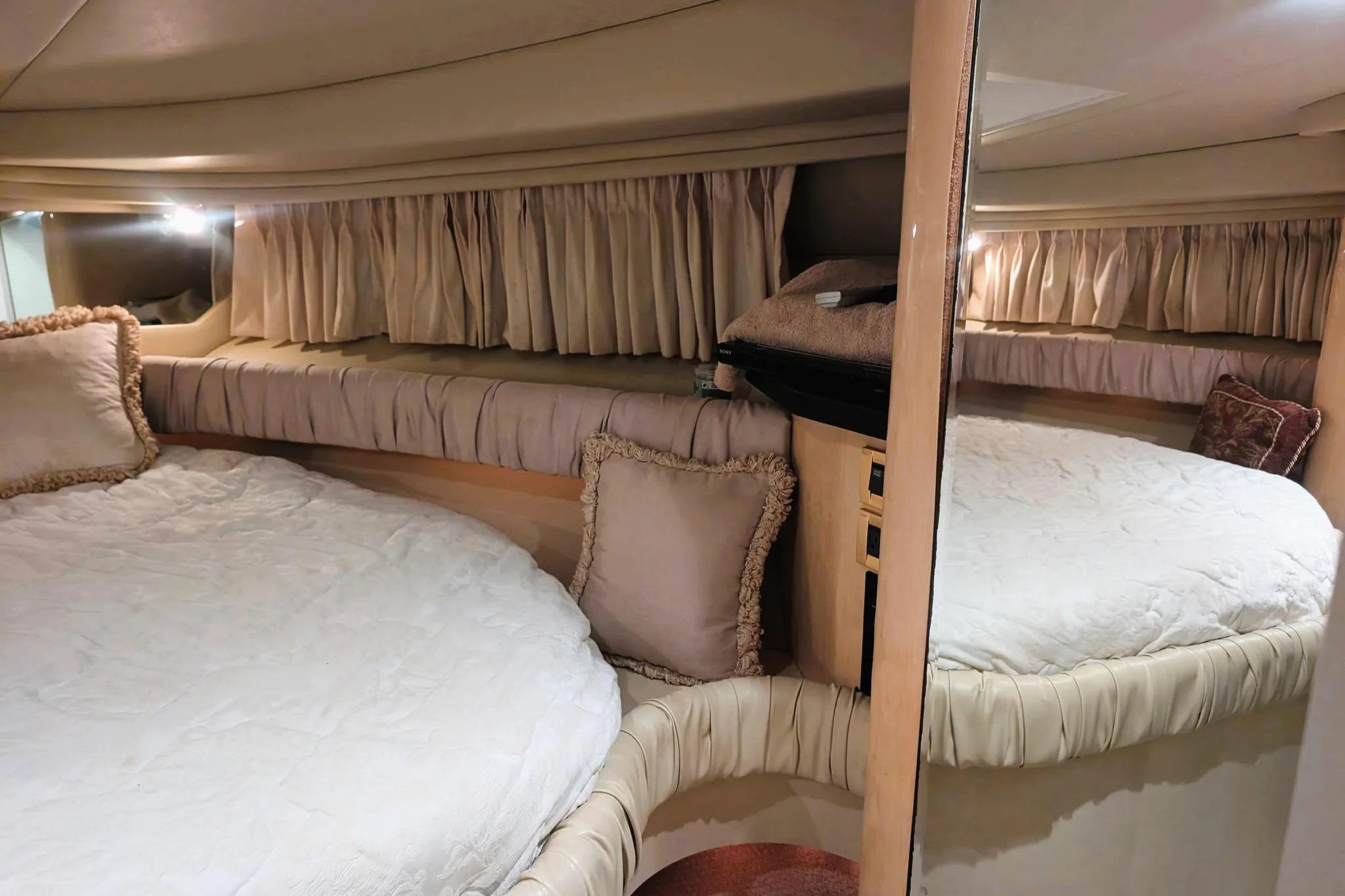 Luxurious interior cabin of 2000 Sea Ray 380 Sundancer yacht with plush bedding.