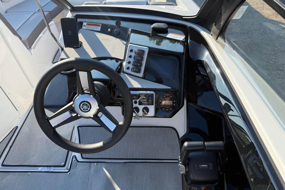 2026 Yamaha Boats AR220 dashboard with steering wheel and control panel.