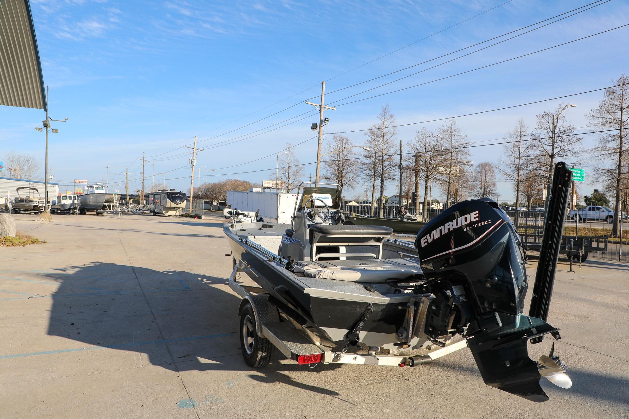 2019 Express 18 boat with Evinrude motor parked outdoors on a sunny day.
