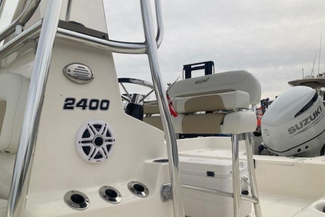 2023 Bulls Bay 2400 boat interior with Suzuki engine, featuring seating and control panel.