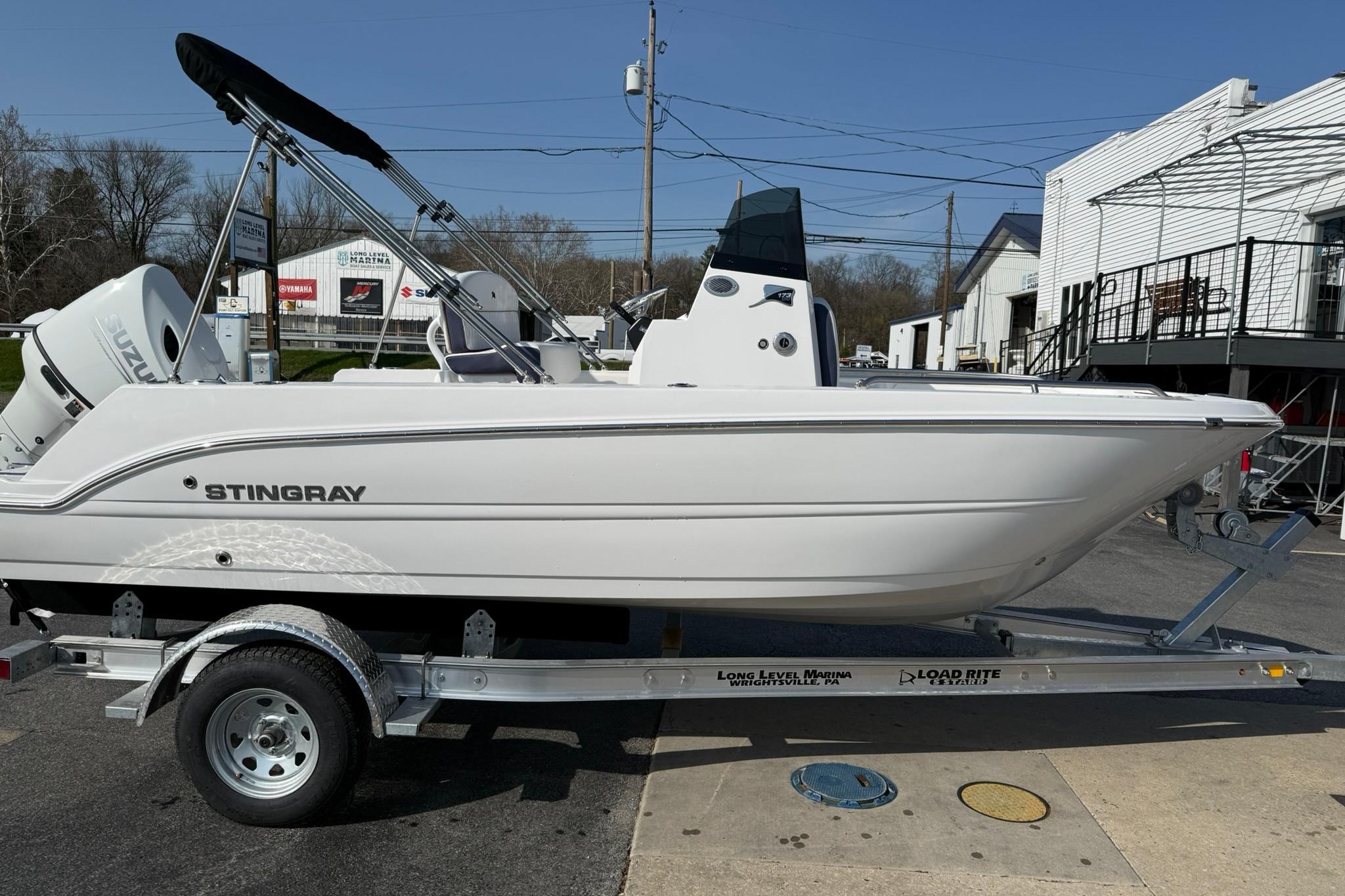 2026 Stingray 173 CC boat on trailer, side view, outdoors.