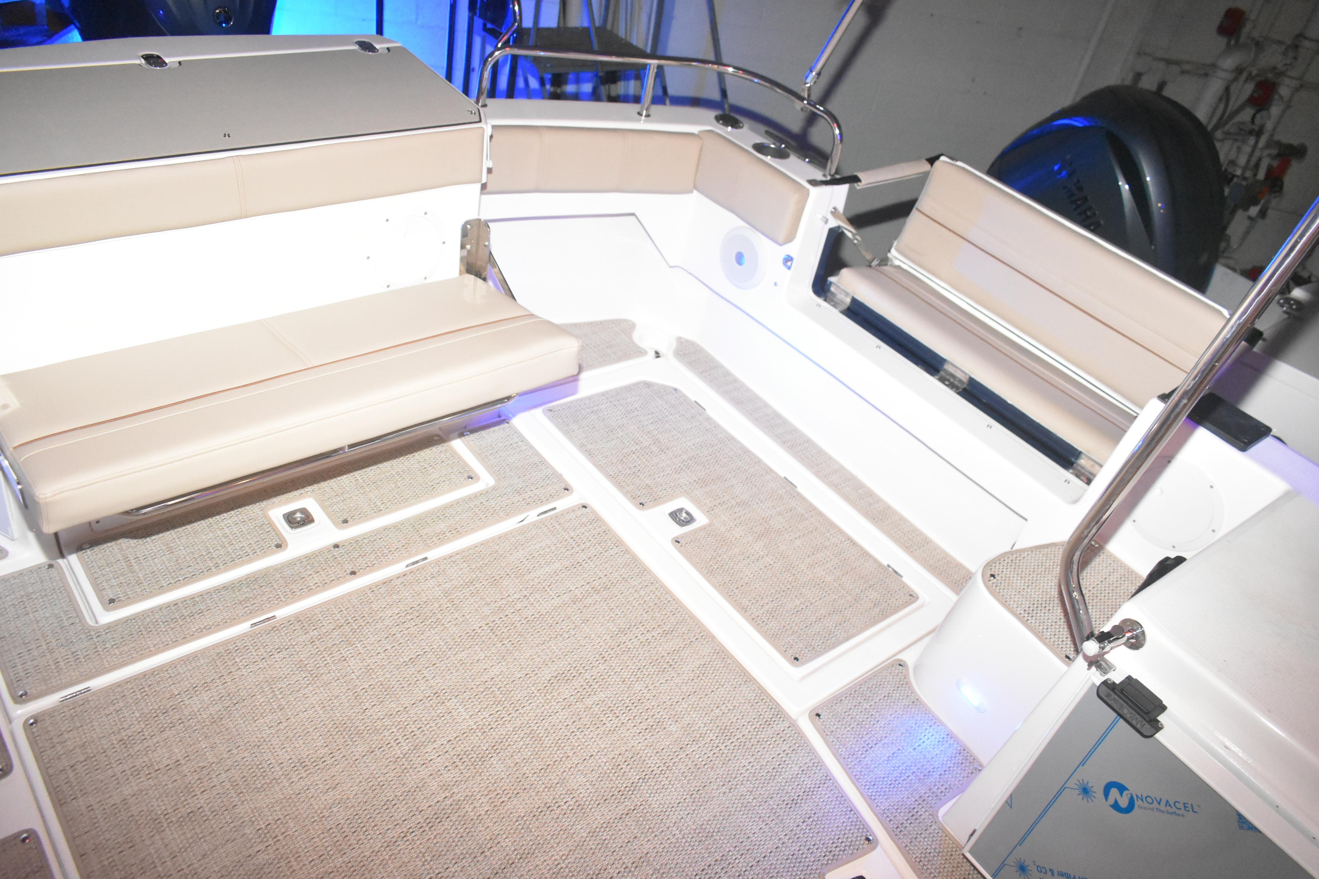 2026 Cutwater C-32 CB boat interior with beige seating and carpeted flooring.