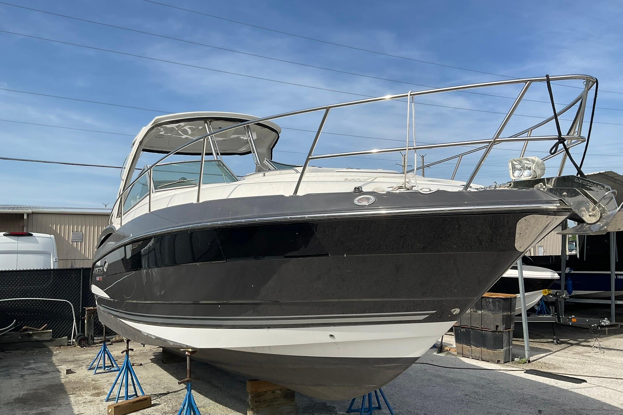 2019 Monterey 335 Sport Yacht on stands, displayed outdoors under clear skies.