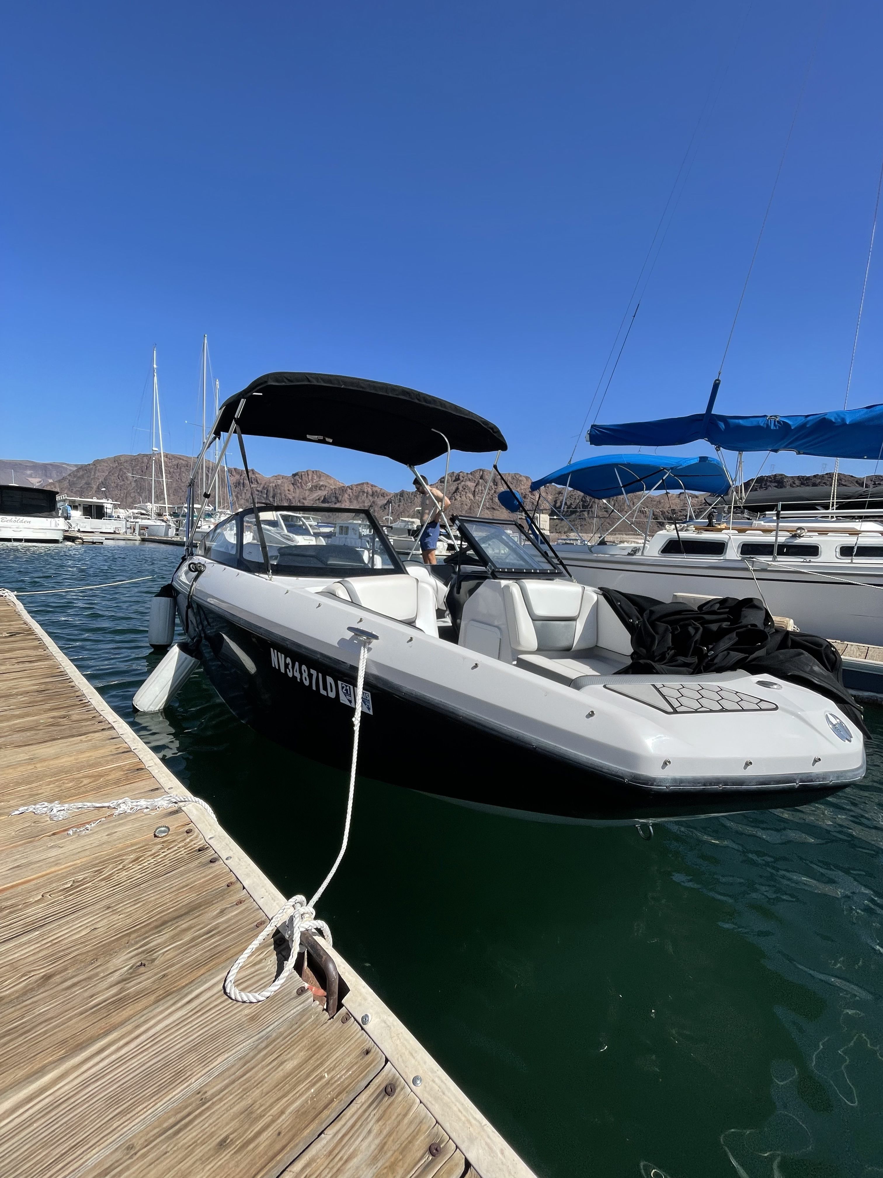 A 2019 Scarab 195 G boat docked on the water.