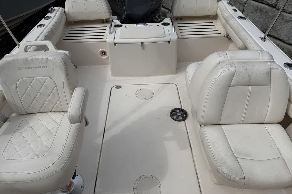 2019 Grady-White Freedom 215 boat interior with white seating and storage compartments.