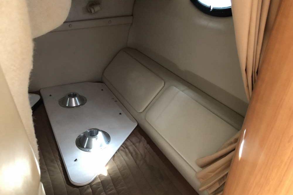 1999 Regal Commodore 2760 cabin interior with seating and table base.