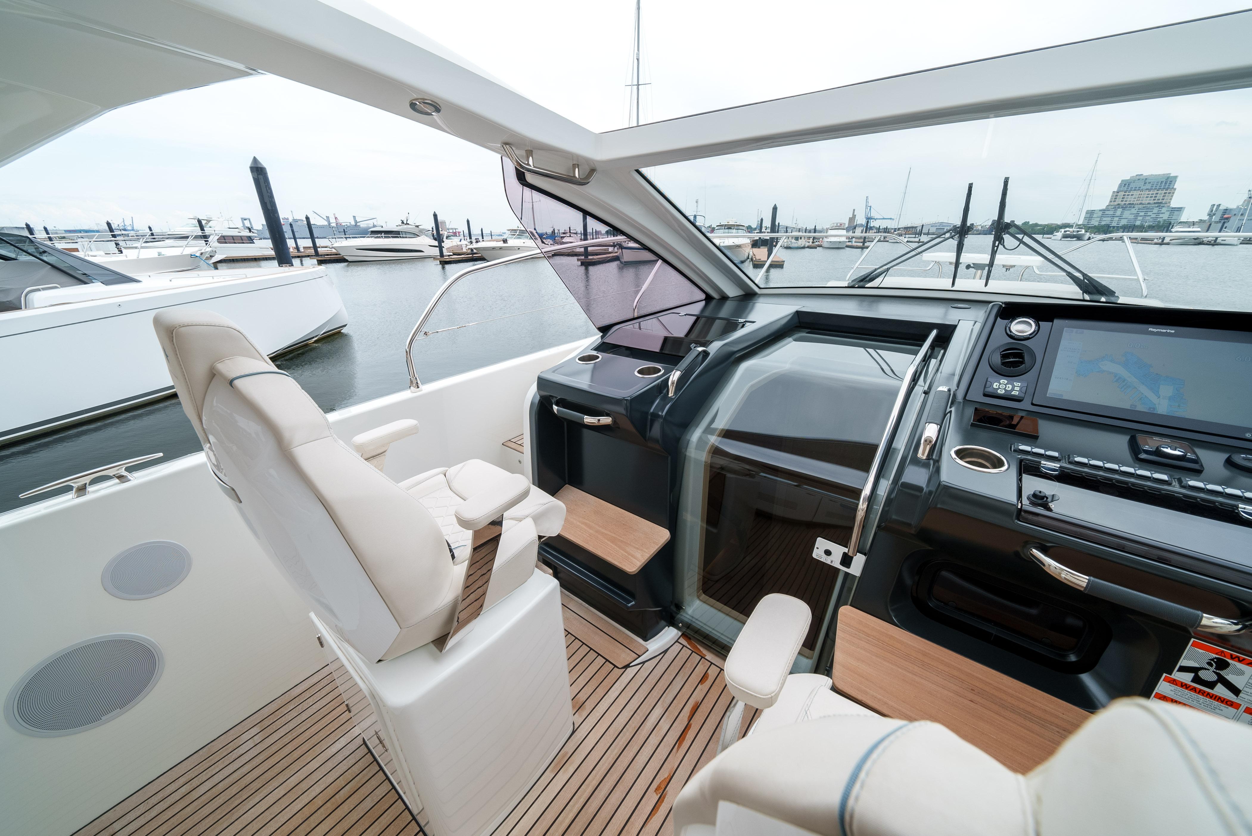 2024 Jeanneau DB/43 OB boat interior with modern helm and seating at marina.