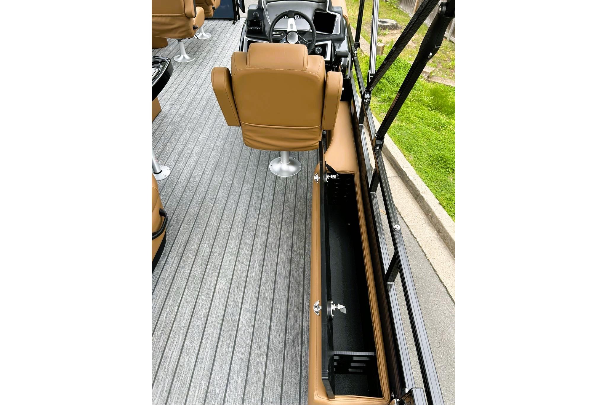 Interior of 2026 Ranger 220FC boat with tan seats and sleek flooring.
