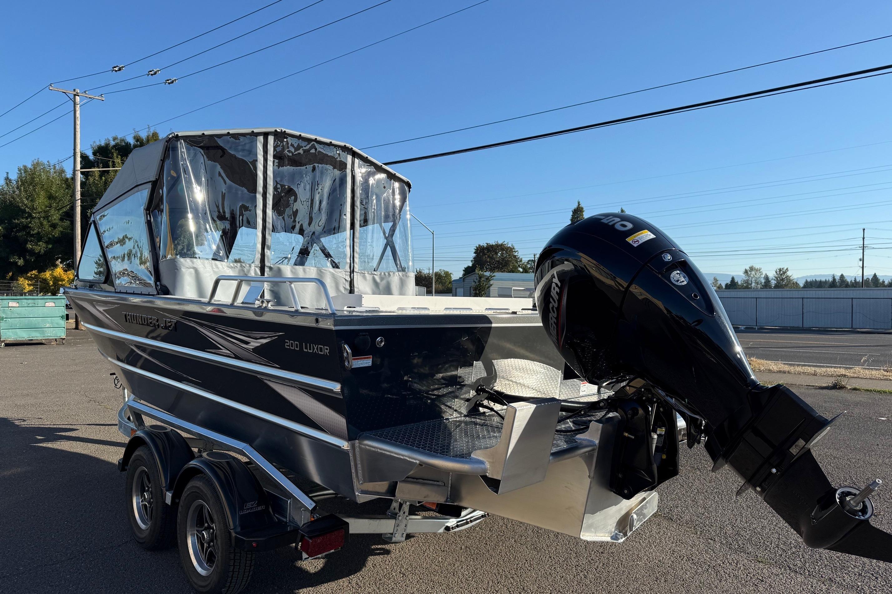 2026 Thunder Jet 200 Luxor boat with outboard motor on a trailer.