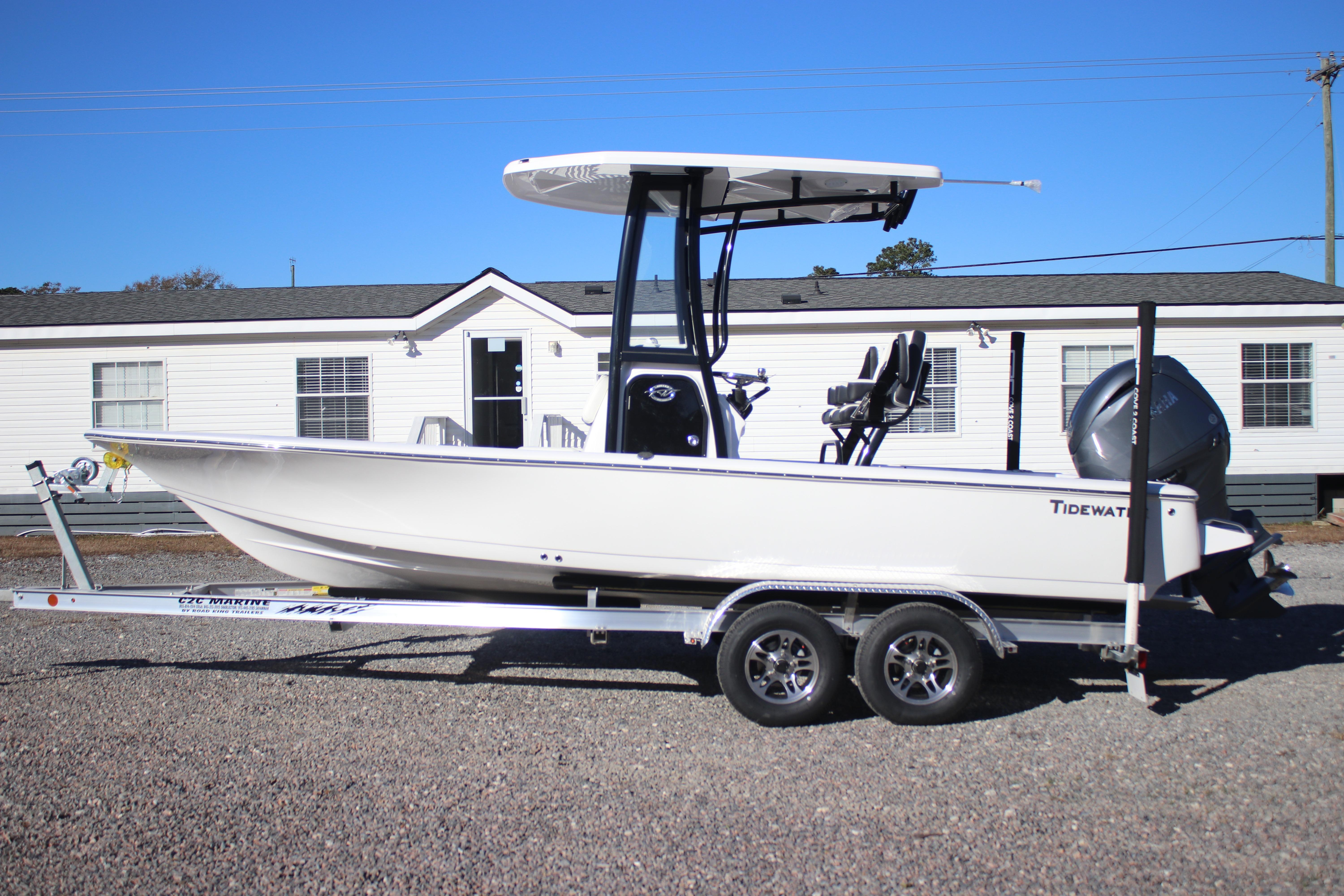 2026 Tidewater 2210 Carolina Bay boat on trailer, parked outdoors under clear blue sky.